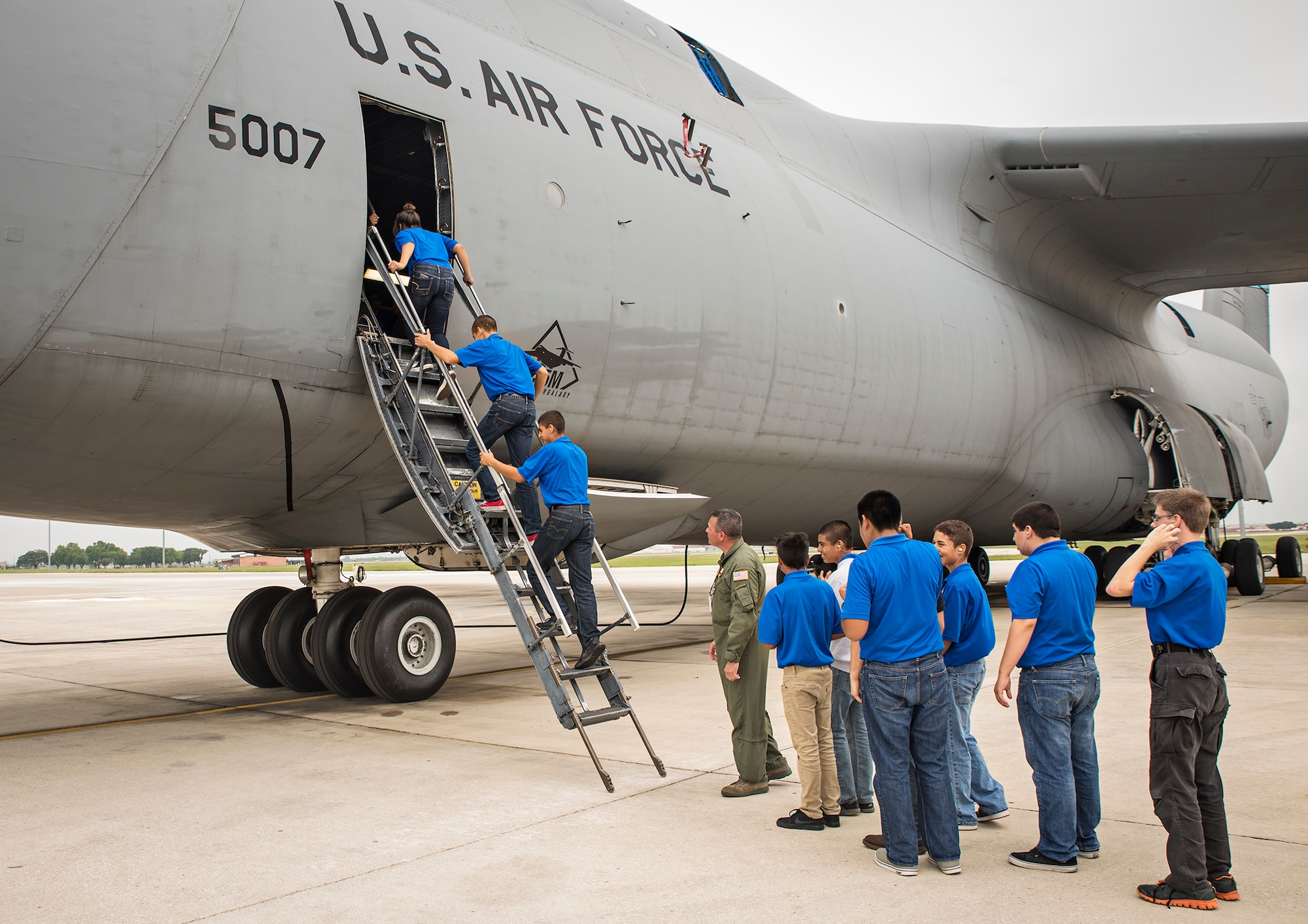 Junior ROTC students from John Jay High School climb into a C-5M Super Galaxy aircraft May 12, 2016 at Joint Base San Antonio-Lackland, Texas. The students toured the survival, engine, and structural engineering shops at the 433rd Airlift Wing and also saw a Military Working Dog demonstration at the 341st Training Squadron. (U.S. Air Force photo by Benjamin Faske) (released)