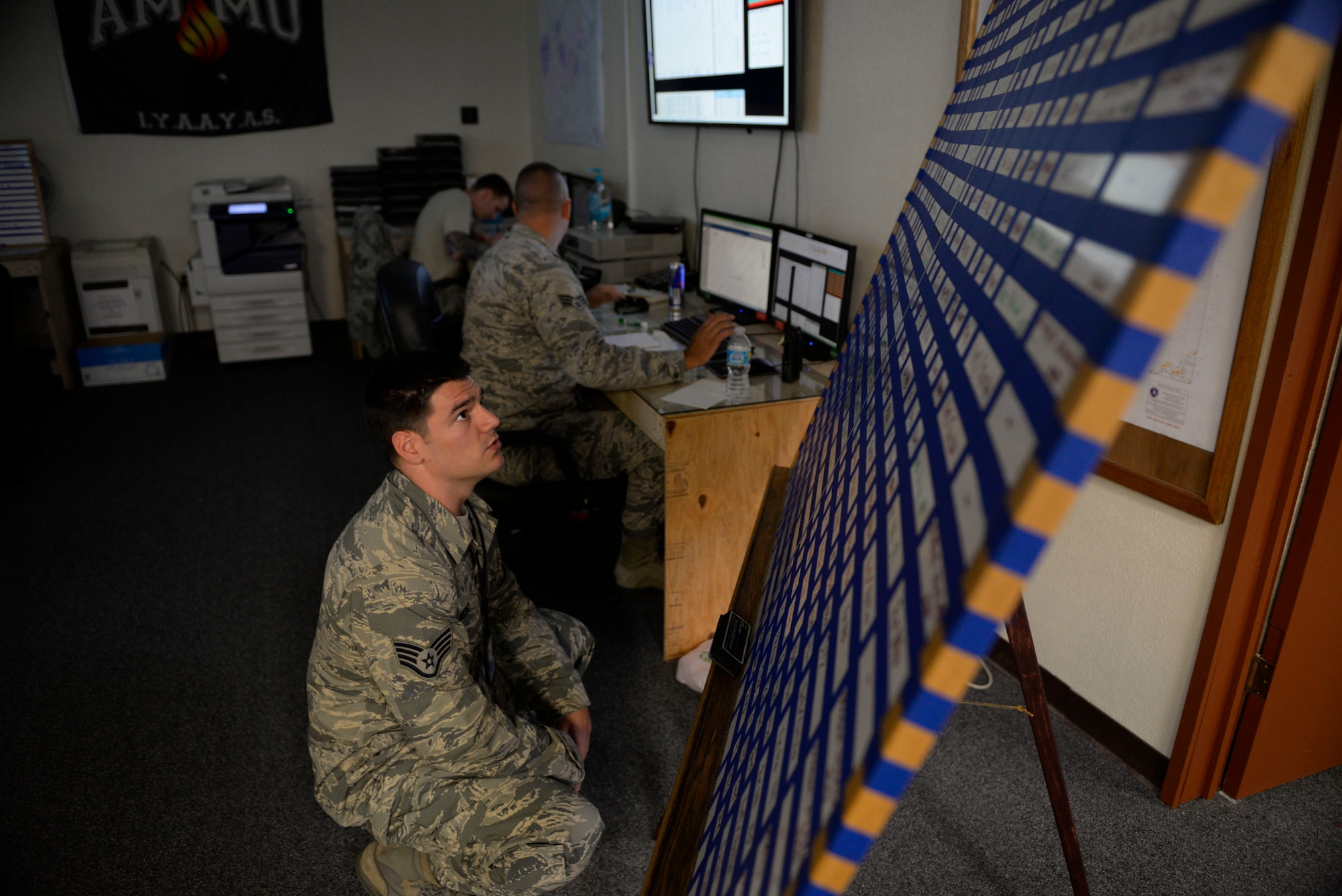 U.S. Air Force Staff Sgt. Jason Lemmond, 18th Munitions Squadron maintenance crew lead, checks the “Frag Board” to make sure that all of the bomb building is being completed on schedule during a week-long Pacific Air Forces Combat Ammunition Production Exercise May 16, 2016, at Kadena Air Base, Japan. The exercise is a Pacific Air Forces exercise held annually to test the munitions Airmen’s ability to build ammunition for wartime aircraft. (U.S. Air Force photo by Senior Airman Stephen G. Eigel/Released)
