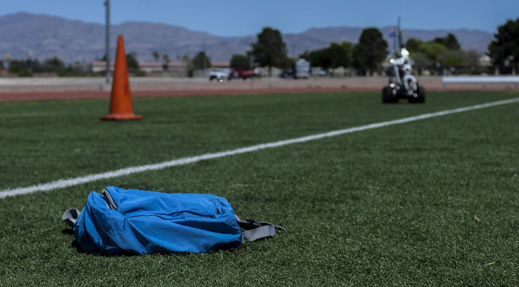 99th Civil Engineer Squadron explosive ordinance disposal uses a robot to survey a suspicious package left at the scene of a simulated active shooter during a base exercise at Nellis Air Force Base, Nev., May 12, 2016. The EOD robot is fitted with camera and a mechanical arm in order to observe areas surrounding a possible explosive before sending in an EOD Tech. (U.S. Air Force photo by Airman 1st Class Kevin Tanenbaum)