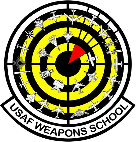 The current Weapons School patch design, adopted in 2016, reflects the expansion of the school, with 28 aircraft and weapons systems encircling a red “bomb on target” over a black and yellow bullseye background. 