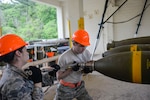U.S. Air Force Senior Airman Talia lamanuzzi, 366th Equipment Maintenance Squadron bomb inspector, and Airman 1st Class Jacob Israel, 18th Munitions Squadron munitions crew chief, torque the head onto a “Big Bomb” during a week-long Pacific Air Forces Combat Ammunition Production Exercise May 16, 2016, at Kadena Air Base, Japan. Units from Air Combat Command and Pacific Air Forces participated in the exercise to test the munitions Airmen’s ability to build ammunition for wartime aircraft. 