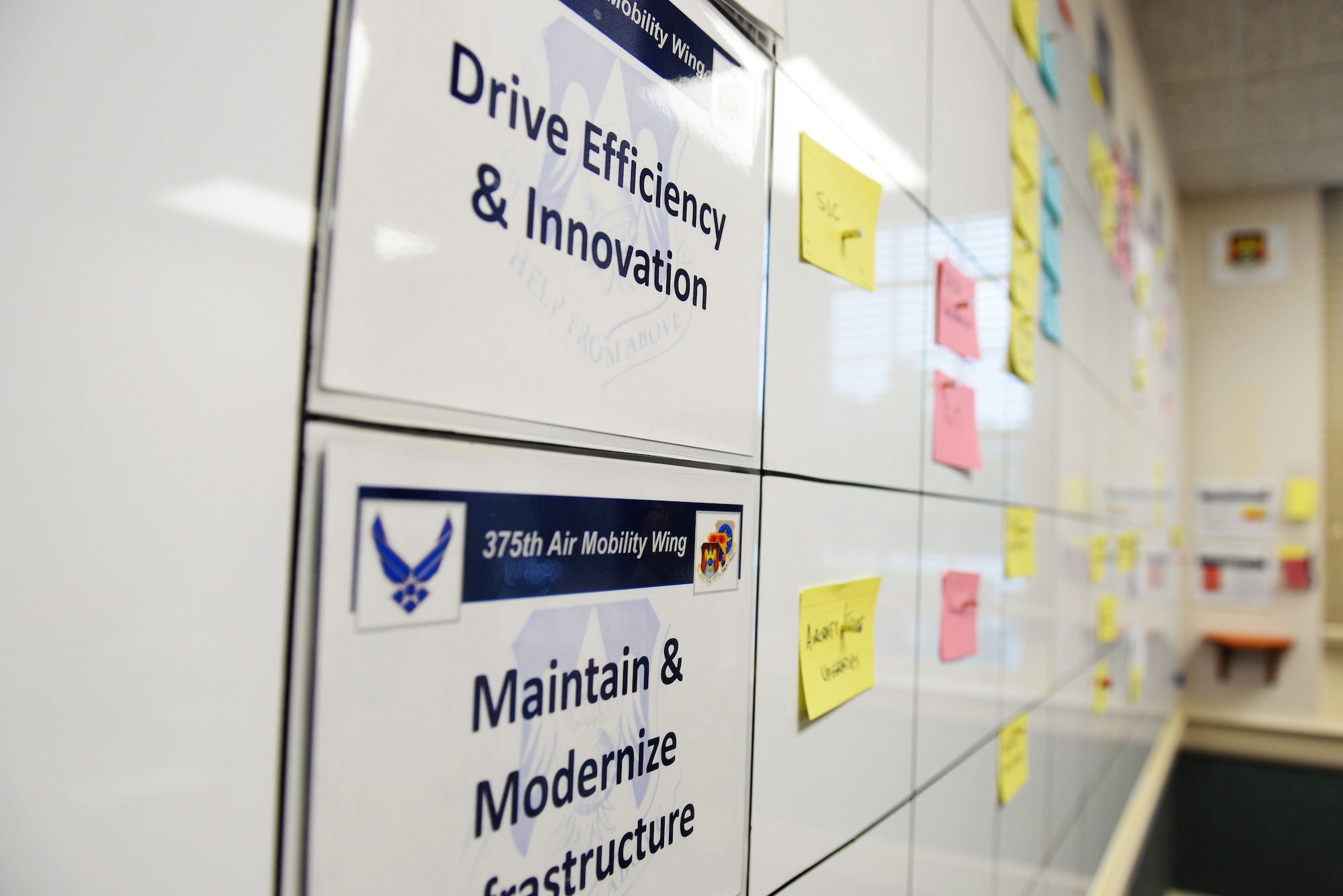 The design of the 375th Air Mobility Wing engine room at Scott Air Force Base, Ill., includes work action cards that outline an issue, and they are then placed on the wall-sized board under certain priorities they fall under. This is a continuous process improvement model aimed at transparency and ‘embracing the red’, which means knowing what all the issues are so it can be addressed before it is a bigger issue. (U.S. Air Force photo/Senior Airman Erica Fowler)