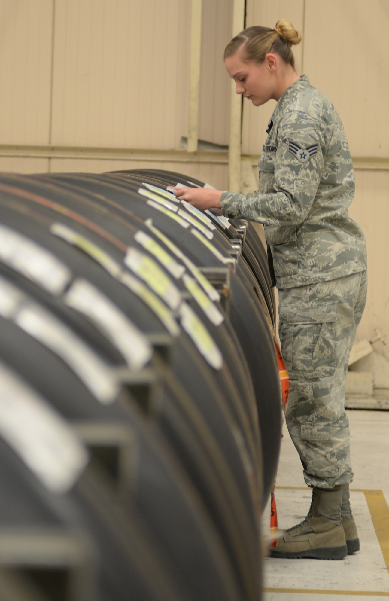Senior Airman Jessica Stainbrook, 28th Logistics Readiness Squadron aircraft parts store journeyman, inspects a tire to ensure that it is mission ready at Ellsworth Air Force Base, S.D., April 25, 2016. The flight supplies parts to B-1 bomber locations, and once the item is processed, an automatic replenishing code ensures sent items are replaced to be used in the future. (U.S. Air Force photo by Airman 1st Class Sadie Colbert/Released)