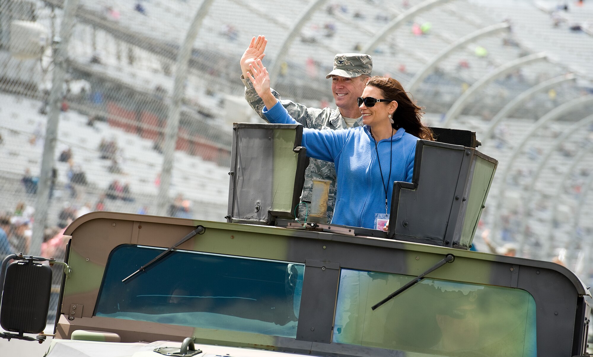 Col. Kevin Gordon, 436th Airlift Wing vice commander, Dover Air Force Base, Del., and his wife, Heather, wave to the crowd during the parade lap prior to the start of the AAA 400 Drive for Autism NASCAR Sprint Cup Series race May 15, 2016, at Dover International Speedway, Dover, Del. Members of the 436th and 512th Airlift Wings took part in pre-race ceremonies. (U.S. Air Force photo/Roland Balik)