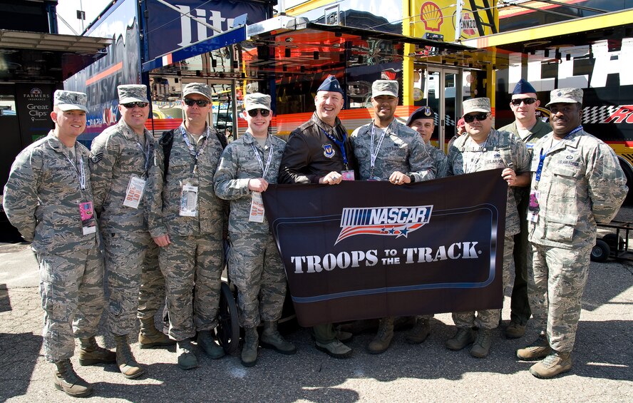 Maj. Gen. Jon A. Norman, Director of Global Power Programs in the Office of the Assistant Secretary of the Air Force for Acquisition, Headquarters U.S. Air Force, Washington, D.C., stands with Team Dover members during a tour of the garage area May 15, 2016, at Dover International Speedway, Dover, Del. The Troops to the Track program allows service men and women to get an upfront day-long experience at NASCAR races throughout the country. (U.S. Air Force photo/Roland Balik)