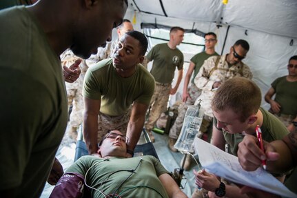 Sailors assigned to Surgical Company B, 4th Medical Battalion, treat a simulated patient during a five-day medical field exercise May 13, 2016 at Joint Base Charleston, S.C. The exercise tested the capabilities of Surgical Company B’s forward resuscitative surgical system, or FRSS, which is a rapidly mobile trauma surgical team designed to be in close proximity to combat units on the battlefield. (U.S. Air Force photo/Staff Sgt. Jared Trimarchi) 