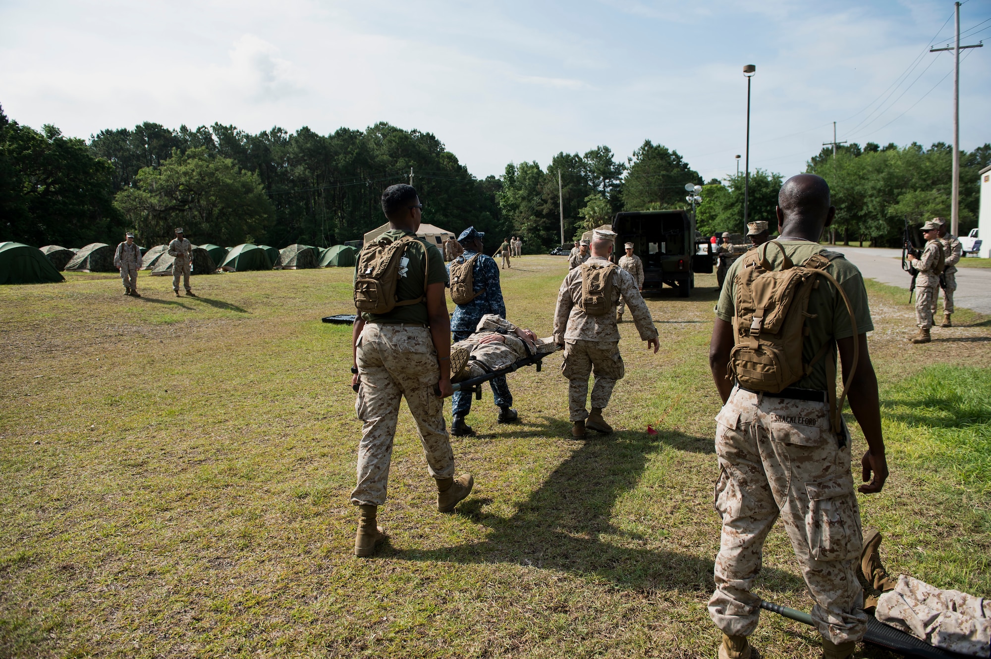 Sailors assigned to Surgical Company B, 4th Medical Battalion, transport a simulated patient during a five-day medical field exercise May 13, 2016 at Joint Base Charleston, S.C. The exercise tested the capabilities of Surgical Company B’s forward resuscitative surgical system, or FRSS, which is a rapidly mobile trauma surgical team designed to be in close proximity to combat units on the battlefield. (U.S. Air Force photo/Staff Sgt. Jared Trimarchi) 