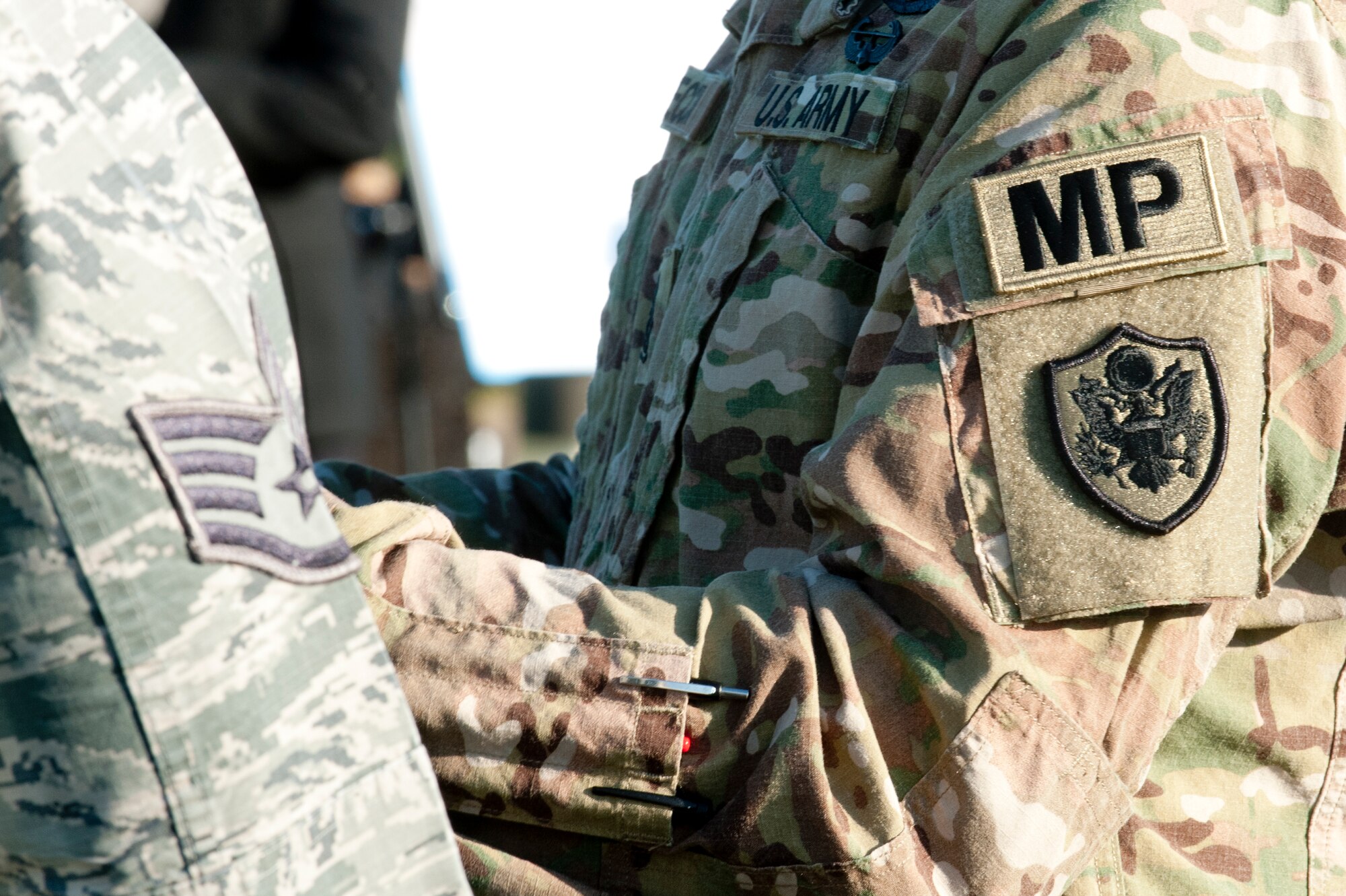 A U.S. Airman and Soldier participate in a National Police Week opening ceremony at Langley Air Force Base, Va., May 16, 2016. Each year, May 15 marks Peace Officers' Memorial Day and the week in which the date falls as Police Week, which recognizes law enforcement officers who lost their lives in the line of duty. (U.S. Air Force photo by Staff Sgt. R. Alex Durbin)