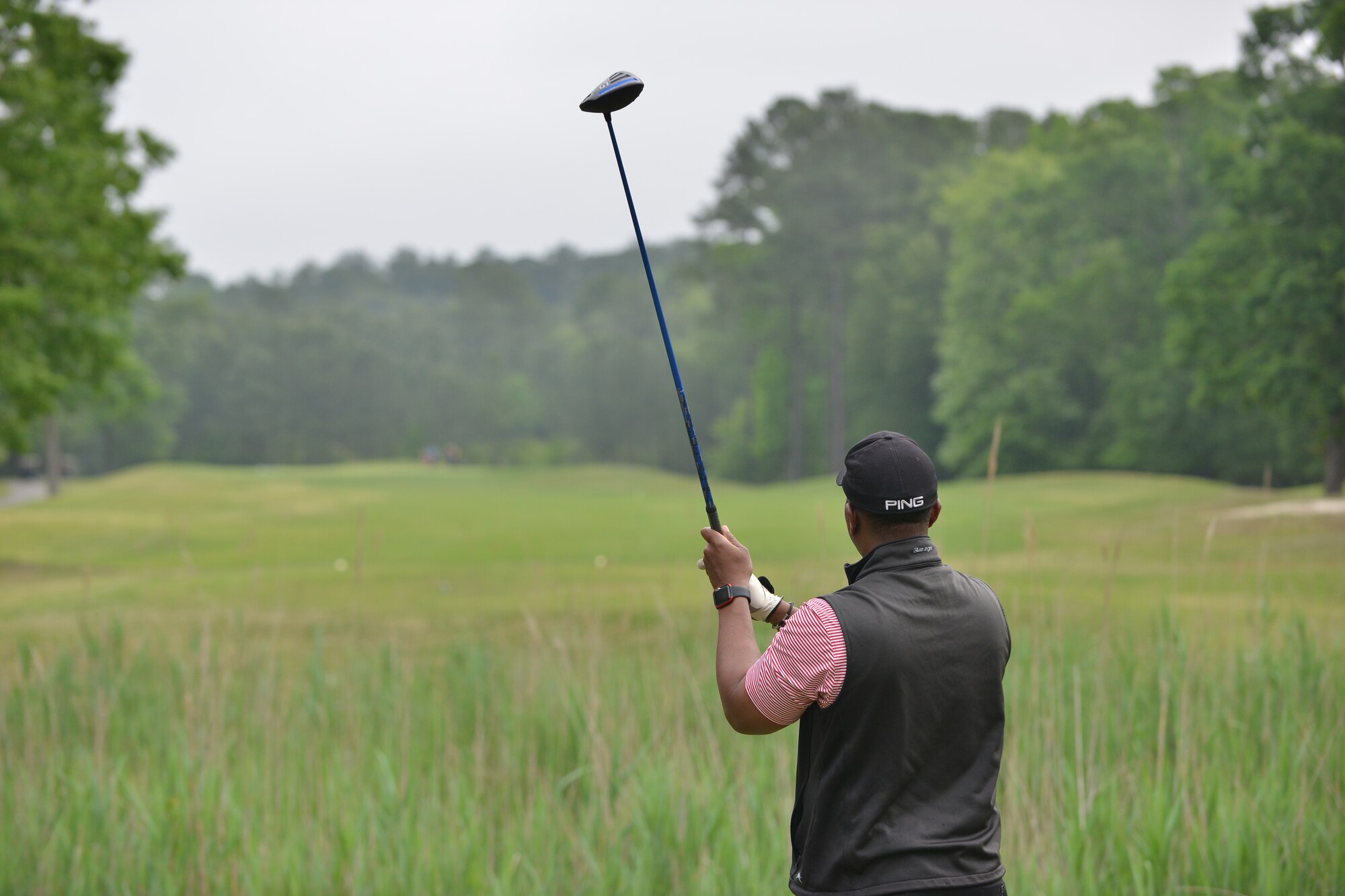 A Commander’s Cup Golf Tournament participant watches his golf ball head down the fairway at Fort Eustis, Va., May 13, 2016. The tournament takes place annually to promote esprit de corps between the Services and civilian counterparts. (U.S. Air Force photo by Staff Sgt. Natasha Stannard)