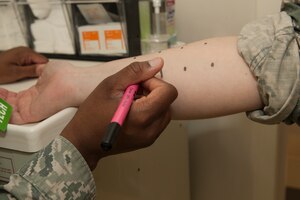 U.S. Air Force Staff Sgt. Lucretia Cunningham, an allergy and immunization technician assigned to the 633rd Medical Operations Squadron, prepares a patient for an allergy skin test at Langley Air Force Base, Va., May 12, 2016. Along with skin testing, the allergy and immunization clinic offers asthma, venom and medication testing. (U.S. Air Force photo by Airman 1st Class Kaylee Dubois) 