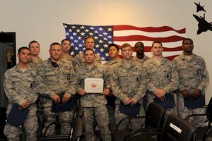 U.S. Airmen with the 633rd Security Forces Squadron and 633rd Civil Engineer Squadron celebrate their graduation from the Newport News SWAT school at Langley Air Force Base, Va., May 18, 2016. Through the 10-day course, the Airmen were trained alongside Newport News and Hampton police officers by National Tactical Association officers in active shooter response, building entries, hostage rescue and live-fire. (U.S. Air Force photo by Airman 1st Class Kaylee Dubois)
