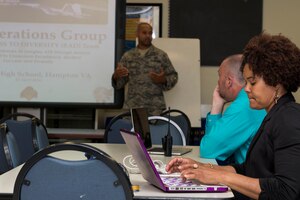 Teachers listen and take notes as U.S. Air Force Senior Master Sgt. Terrell Rogers, co-founder and chair for Real Access to Diversity team, presents the program at Phoebus High School, Va., April 13, 2016. The RAD team visits local high schools to interact, mentor and bring relevance to the student’s course work by using their experience in the Air Force. (U.S. Air Force photo by Airman 1st Class Derek Seifert)