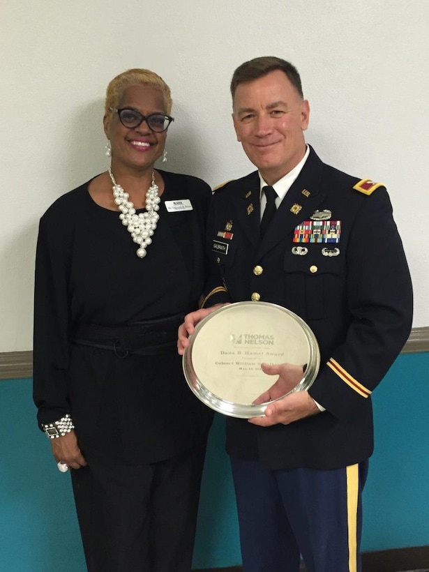 U.S. Army Col. William S. Galbraith, commander of the 733rd Mission Support Group, receives the Dana B. Hamel Award from Thomas Nelson Community College during their 47th annual commencement ceremony at the Hampton Coliseum in Hampton, Va., May 12, 2016. The award honors citizens who champion higher education and public service. Named in honor of Dr. Dana B. Hamel, the first chancellor of Virginia's Community Colleges, the award recognizes individuals for their commitment to public service; to fostering access to higher education and promoting an understanding of the role of workforce development as an essential part of Thomas Nelson's mission. (courtesy photo)