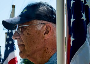 A member of the Patriot Guard stands at attention with the U.S. flag during the Bronze Cross memorial unveiling ceremony in Magnolia Park at Fort Eustis, Va., May 14, 2016. The Patriot Guard was formed in 2005, to protect deceased Service members’ funeral from protestors. (U.S. Air Force photo by Staff Sgt. J.D. Strong II)