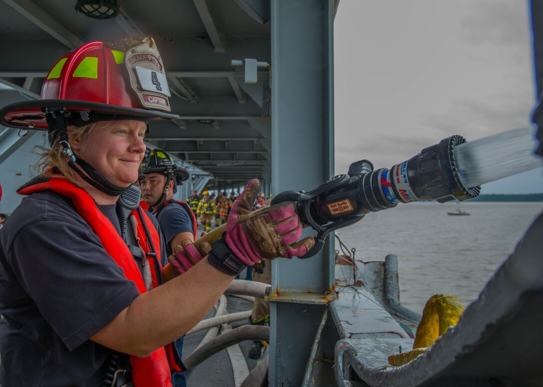 A student of the 25th Annual Hampton Roads Marine Firefighting School maritime incident response exercise performs an operation check on a fire hose at Fort Eustis, Va., May 13, 2016. The capstone tested maritime incident procedures including logistics, command and control, response and rescue. (U.S. Air Force photo by Staff Sgt. J.D. Strong II)