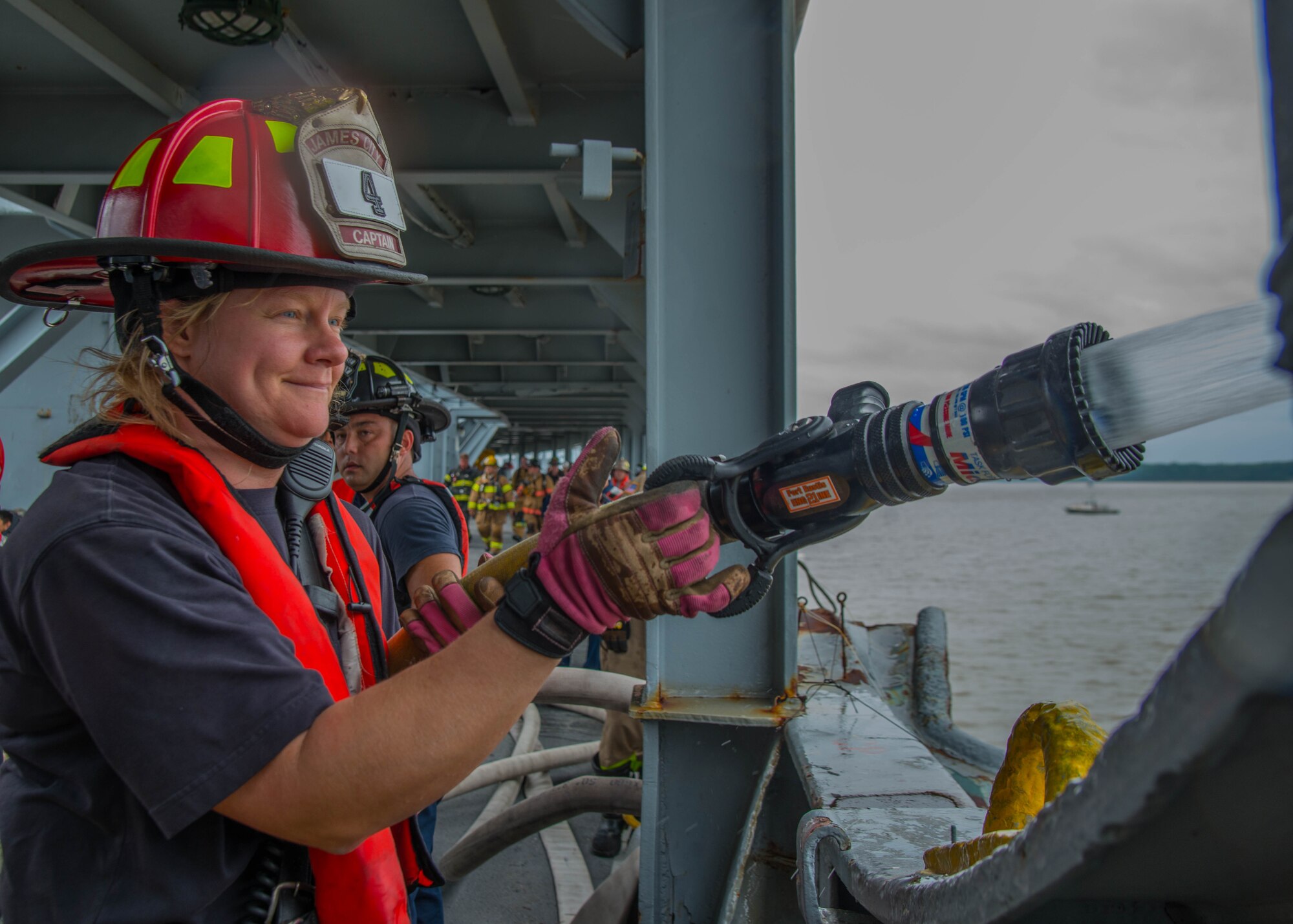 A student of the 25th Annual Hampton Roads Marine Firefighting School maritime incident response exercise performs an operation check on a fire hose at Fort Eustis, Va., May 13, 2016. The capstone tested maritime incident procedures including logistics, command and control, response and rescue. (U.S. Air Force photo by Staff Sgt. J.D. Strong II)