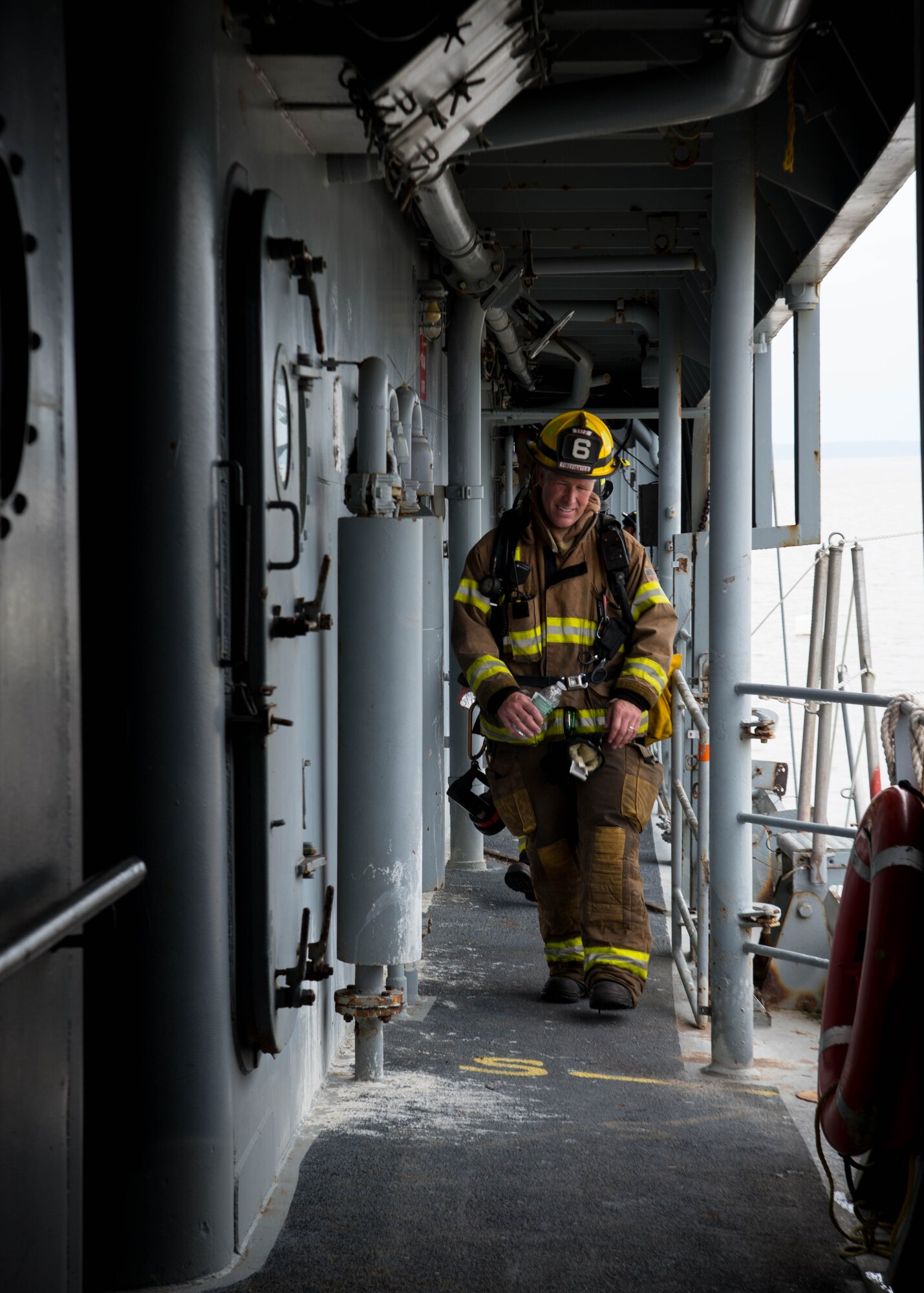 A student of the 25th Annual Hampton Roads Marine Firefighting School maritime incident response exercise walks the deck of the Cape Avinof at Fort Eustis, Va., May 13, 2016. After transferring equipment onto the vessel, the students went through a simulated fire exercise in which they rescued two people from different locations within the ship. (U.S. Air Force photo by Staff Sgt. J.D. Strong II)
