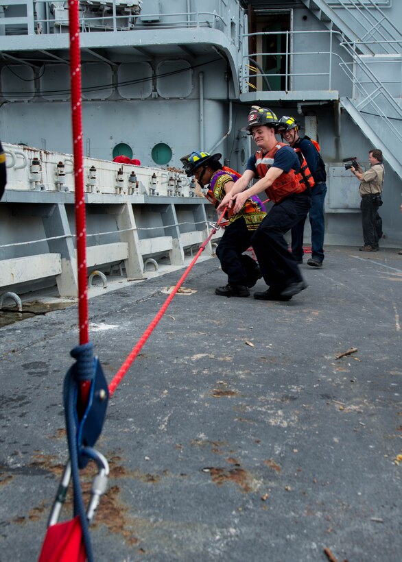 Students of the 25th Annual Hampton Roads Marine Firefighting School maritime incident response exercise prepare their gear to be transported onto the Cape Avinof at Fort Eustis, Va., May 13, 2016. Approximately 130 U.S. civil fire fighters and U.S. and foreign military fire fighters participated in the training. The school not only prepares fire fighters for maritime incident response, but is a way to exchange tactics and ideas to better respond to such incidents. (U.S. Air Force photo by Staff Sgt. J.D. Strong II)