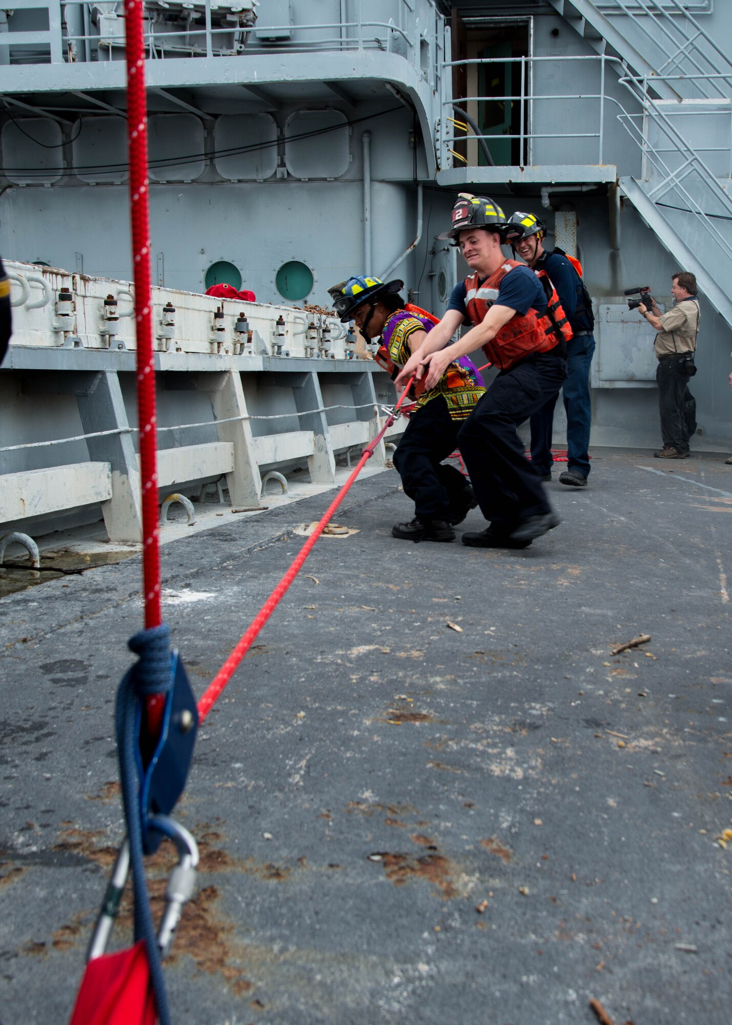 Students of the 25th Annual Hampton Roads Marine Firefighting School maritime incident response exercise prepare their gear to be transported onto the Cape Avinof at Fort Eustis, Va., May 13, 2016. Approximately 130 U.S. civil fire fighters and U.S. and foreign military fire fighters participated in the training. The school not only prepares fire fighters for maritime incident response, but is a way to exchange tactics and ideas to better respond to such incidents. (U.S. Air Force photo by Staff Sgt. J.D. Strong II)