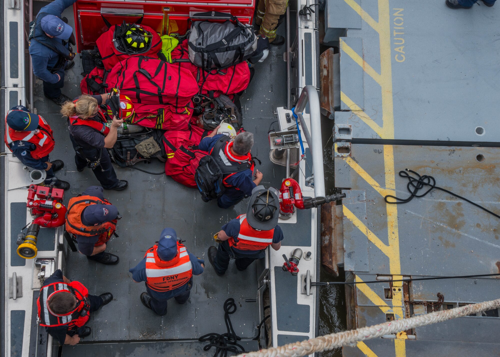 Students of the 25th Annual Hampton Roads Marine Firefighting School maritime incident response exercise prepare their gear to be transported onto the Cape Avinof at Fort Eustis, Va., May 13, 2016. Approximately 130 U.S. civil fire fighters and U.S. and foreign military fire fighters participated in the training. The school not only prepares fire fighters for maritime incident response, but is a way to exchange tactics and ideas to better respond to such incidents. (U.S. Air Force photo by Staff Sgt. J.D. Strong II)