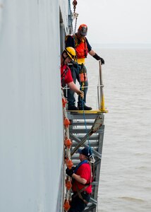 A student climbs a ladder during the 25th Annual Hampton Roads Marine Firefighting School maritime incident response exercise at Fort Eustis, Va., May 13, 2016. The exercise was the capstone event for the school, testing all the students learned about responding to a maritime fire incident. (U.S. Air Force photo by Staff Sgt. J.D. Strong II)
