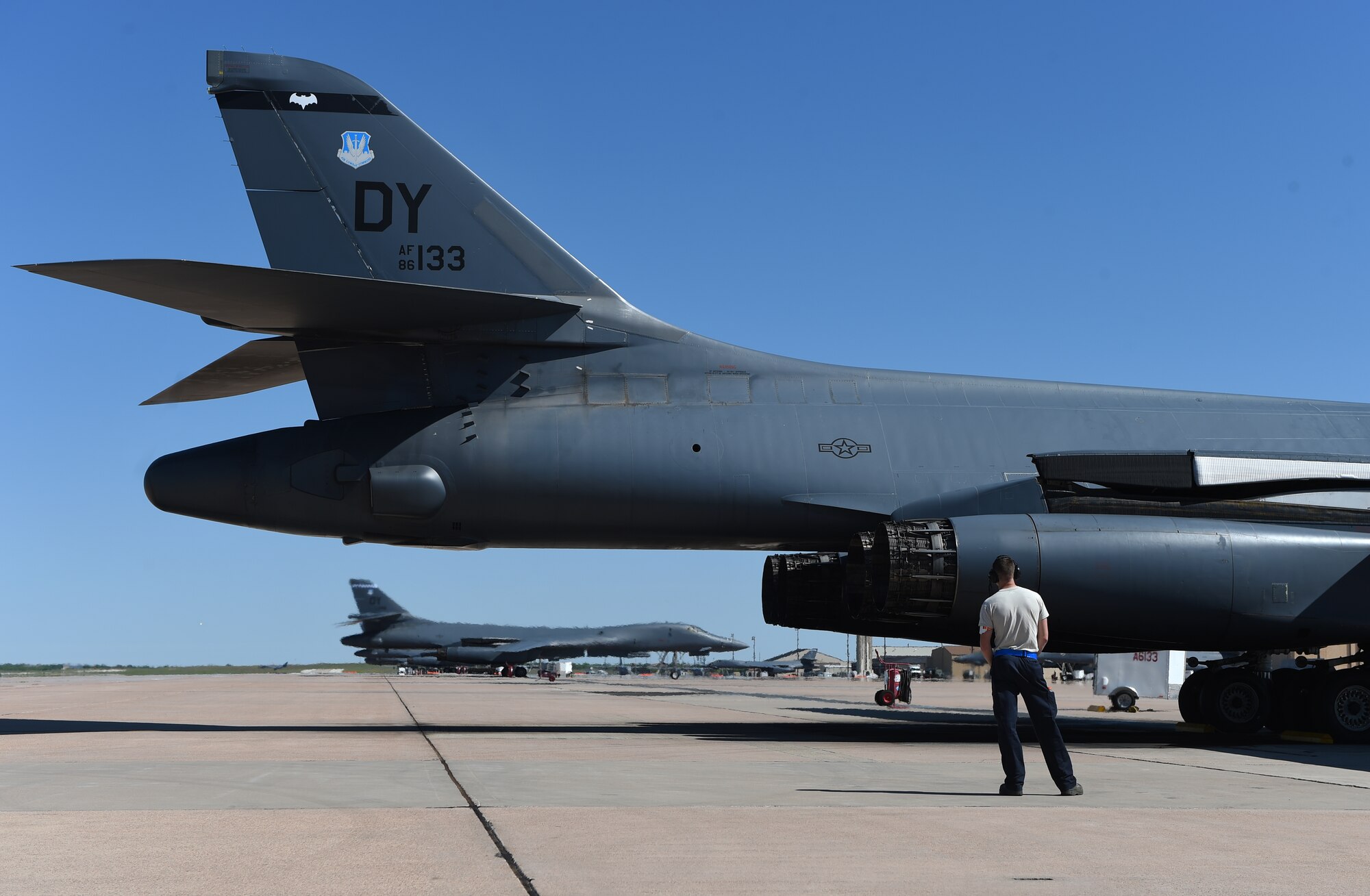 U.S. Air Force Senior Airman Jason Stach, 28th Aircraft Maintenance Unit B-1 aircraft technician, observes a B-1B Lancer during an engine warm-up May 3, 2016, at Dyess Air Force Base, Texas. As part of his job, Stach must perform basic maintenance on the aircraft and inspect it and its components prior to any flight. Stach has been working on the B-1 since he was first stationed here in March 2013 as an inspector in the isochronal hangar and now as an aircraft technician. (U.S. Air Force photo by Senior Airman Alexander Guerrero/Released)