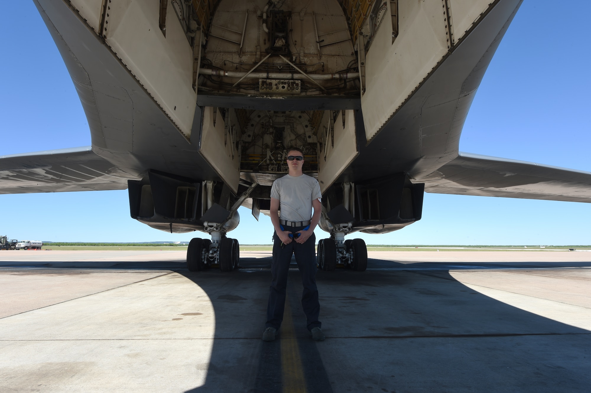 U.S. Air Force Senior Airman Jason Stach, 28th Aircraft Maintenance Unit B-1 aircraft technician, stands in the shade of a B-1B Lancer May 3, 2016, at Dyess Air Force Base, Texas. Stach, who is from Jasper, Florida, joined the Air Force in September 2012. After eight weeks of basic training and a four-month technical school, Stach received orders to be stationed at Dyess and has been here since March 2013. (U.S. Air Force photo by Senior Airman Alexander Guerrero/Released)