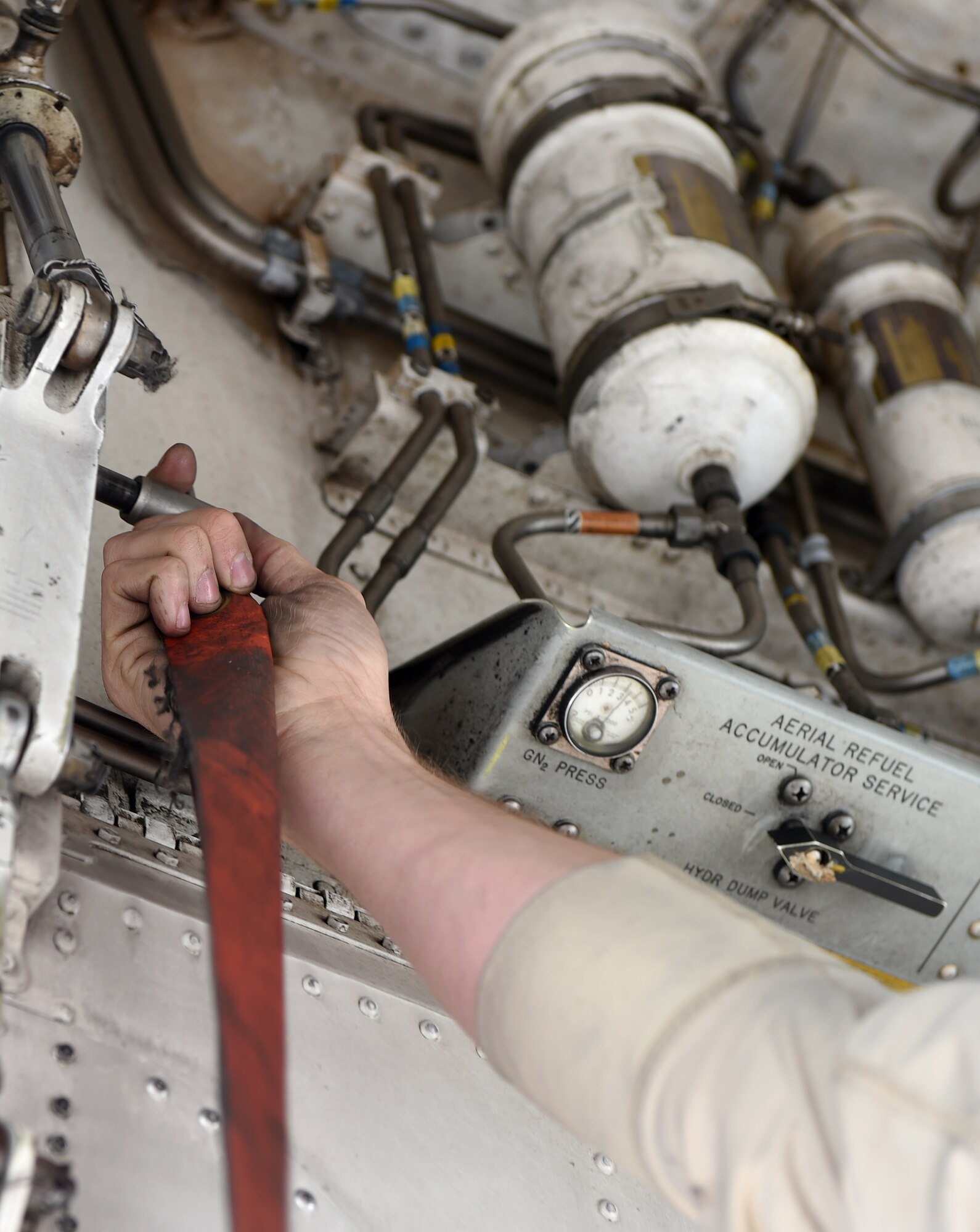 U.S. Air Force Senior Airman Jason Stach, 28th Aircraft Maintenance Unit B-1 aircraft technician, places a safety pin in place to keep the front landing gear doors from closing during maintenance on a B-1B Lancer May 3, 2016, at Dyess Air Force Base, Texas. In order to become a B-1 aircraft technician, Stach had to go through a four-month technical school. Two months of that school consisted of basic aircraft maintenance and terminology and the remainder was hands-on training here at Dyess. (U.S. Air Force photo by Senior Airman Alexander Guerrero/Released)