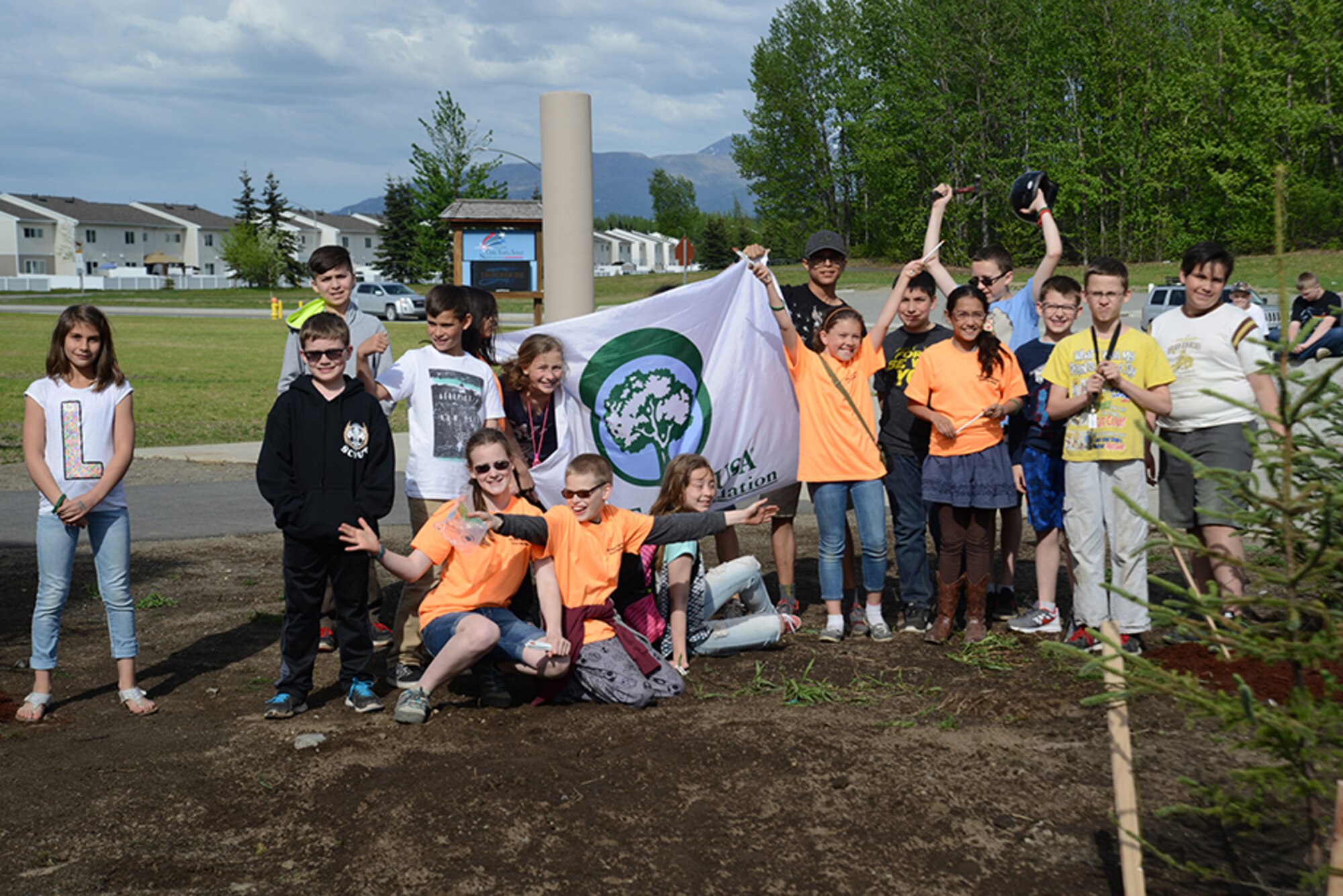 Members of the Torch and Keystone clubs plant two white spruce trees in front of the Two Rivers Youth Center for National Arbor Day at Joint Base Elmendorf-Richardson, May 16, 2016. The trees were provided through a grant from the Alaska Community Forest Council, the Alaska Division of Forestry and the U.S. Forest Service. (U.S. Air Force photo by Airman 1st Class Christopher R. Morales)