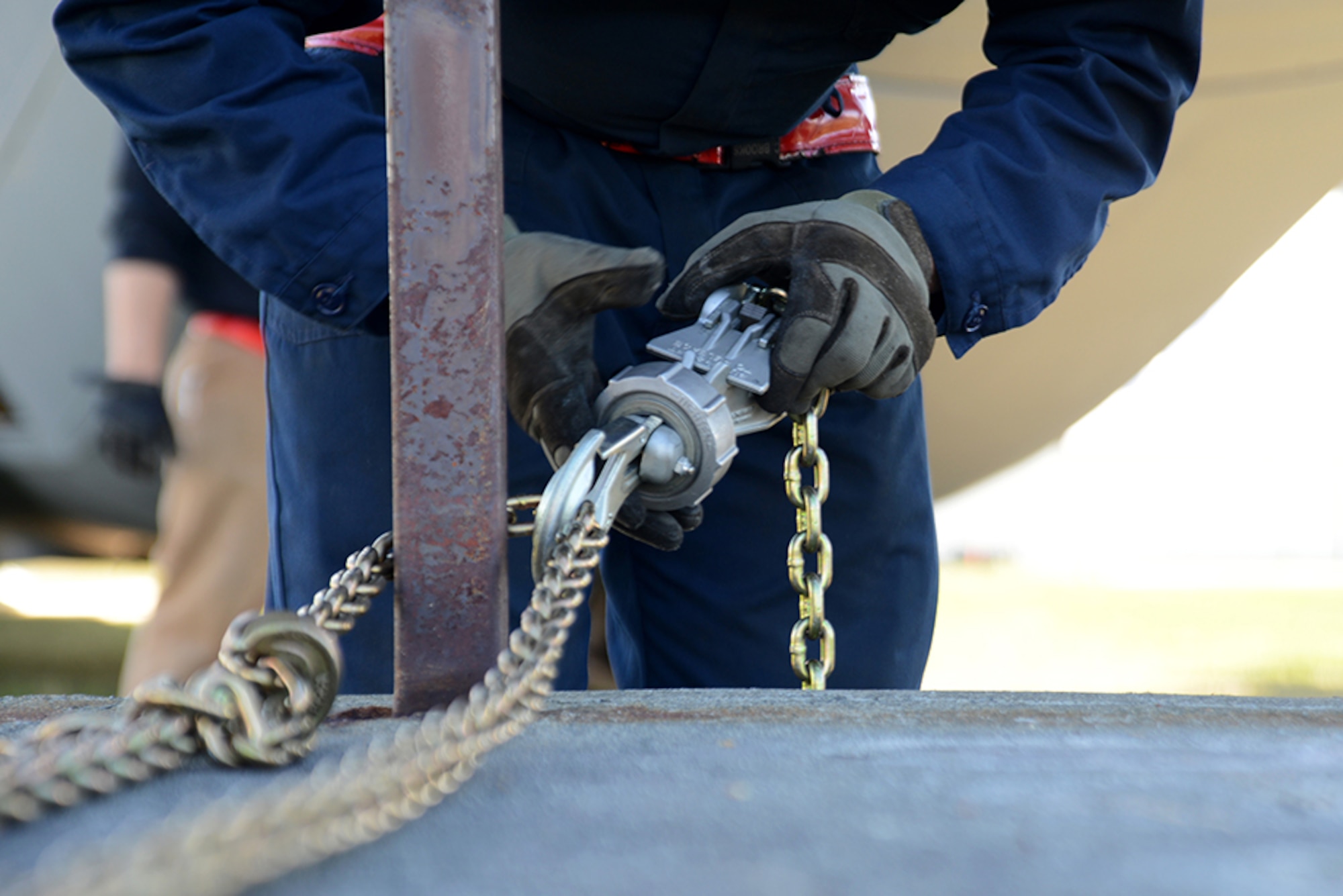 A 3rd Maintenance Squadron Airman tightens the chains on a weight connected to the C-130 Hercules to prevent any unnecessary movement at Heritage Park, Joint Base Elmendorf-Richardson, Alaska, May 7, 2016. Aircraft are refurbished and put on display at Heritage Park to show the base populace retired aircraft which have accomplished the Air Force mission. (U.S. Air Force photo by Airman 1st Class Christopher R. Morales)