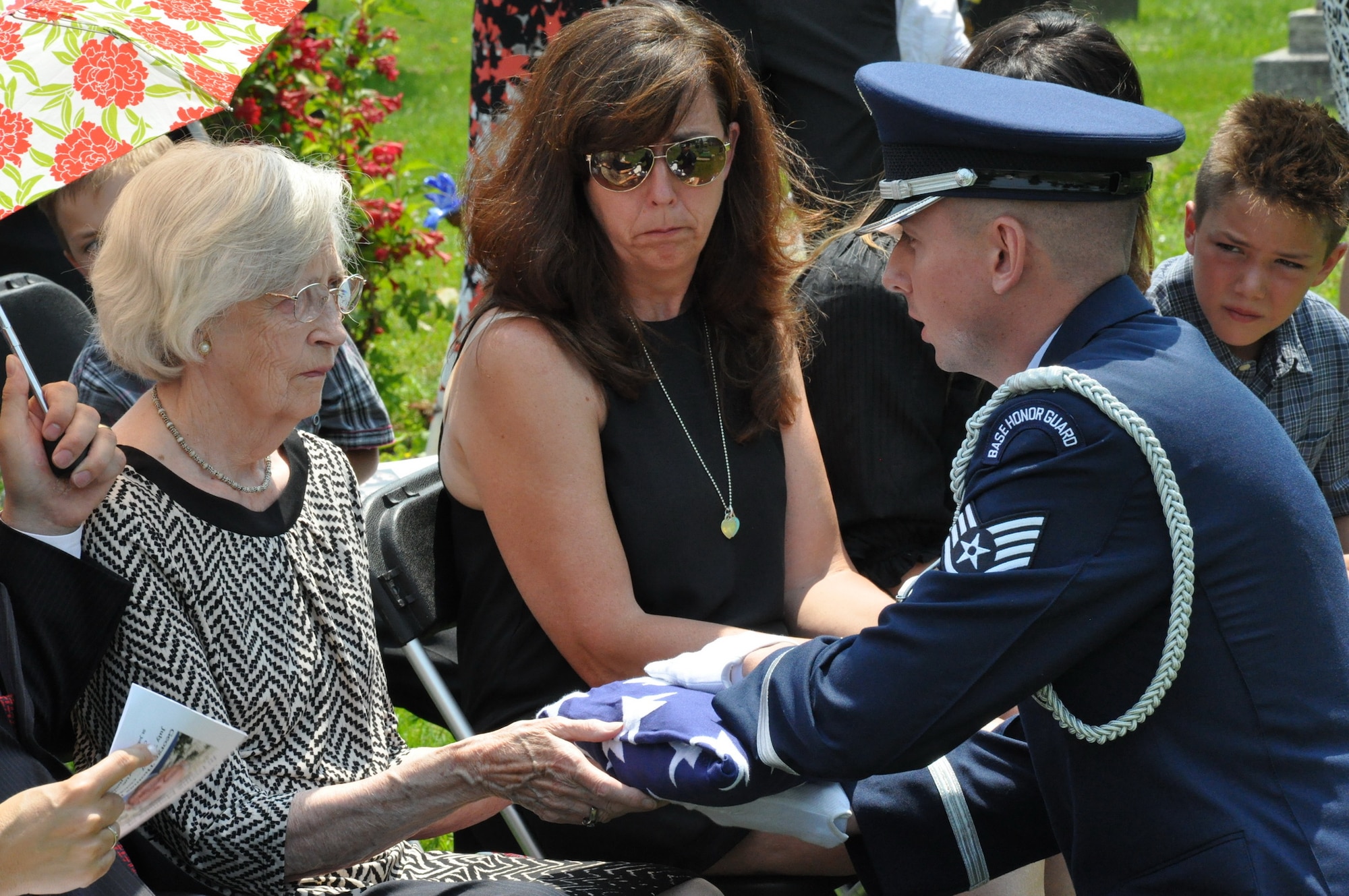 Then-Staff Sgt. Paul A. Cram, Patriot Honor Guard NCO in charge, presents the American flag to George T. Hanrahan's next of kin in Halifax, Nova Scotia, July 8, 2015. Hanrahan served in the Royal Canadian Air Force during World War II and for the United States Air Force during the Korean War. (Courtesy photo)