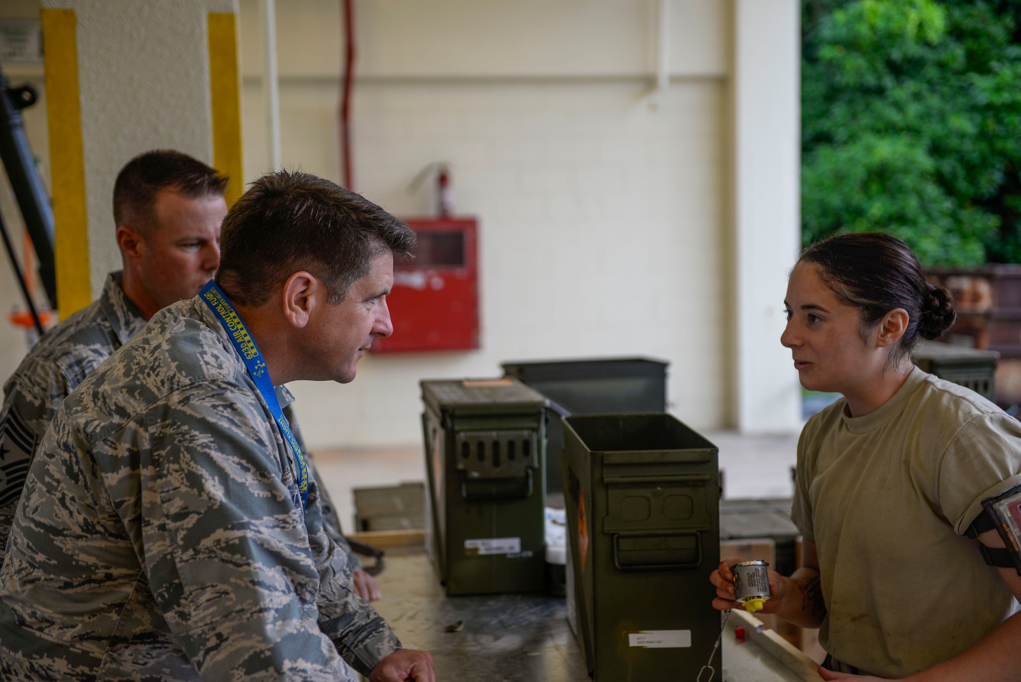 U.S. Air Force Senior Airman Talia lamanuzzi, 366th Equipment Maintenance Squadron bomb inspector, explains the bomb inspection process to Col. Christopher Amrheinn, 18th Wing vice commander, and Chief Master Sgt. Charles Hoffman, 18th Wing command chief, during a week-long Pacific Air Forces Combat Ammunition Production Exercise May 16, 2016, at Kadena Air Base, Japan. The exercise is a Pacific Air Forces exercise held annually to test the munitions Airmen's ability to build ammunition for wartime aircraft. (U.S. Air Force photo by Senior Airman Stephen G. Eigel)