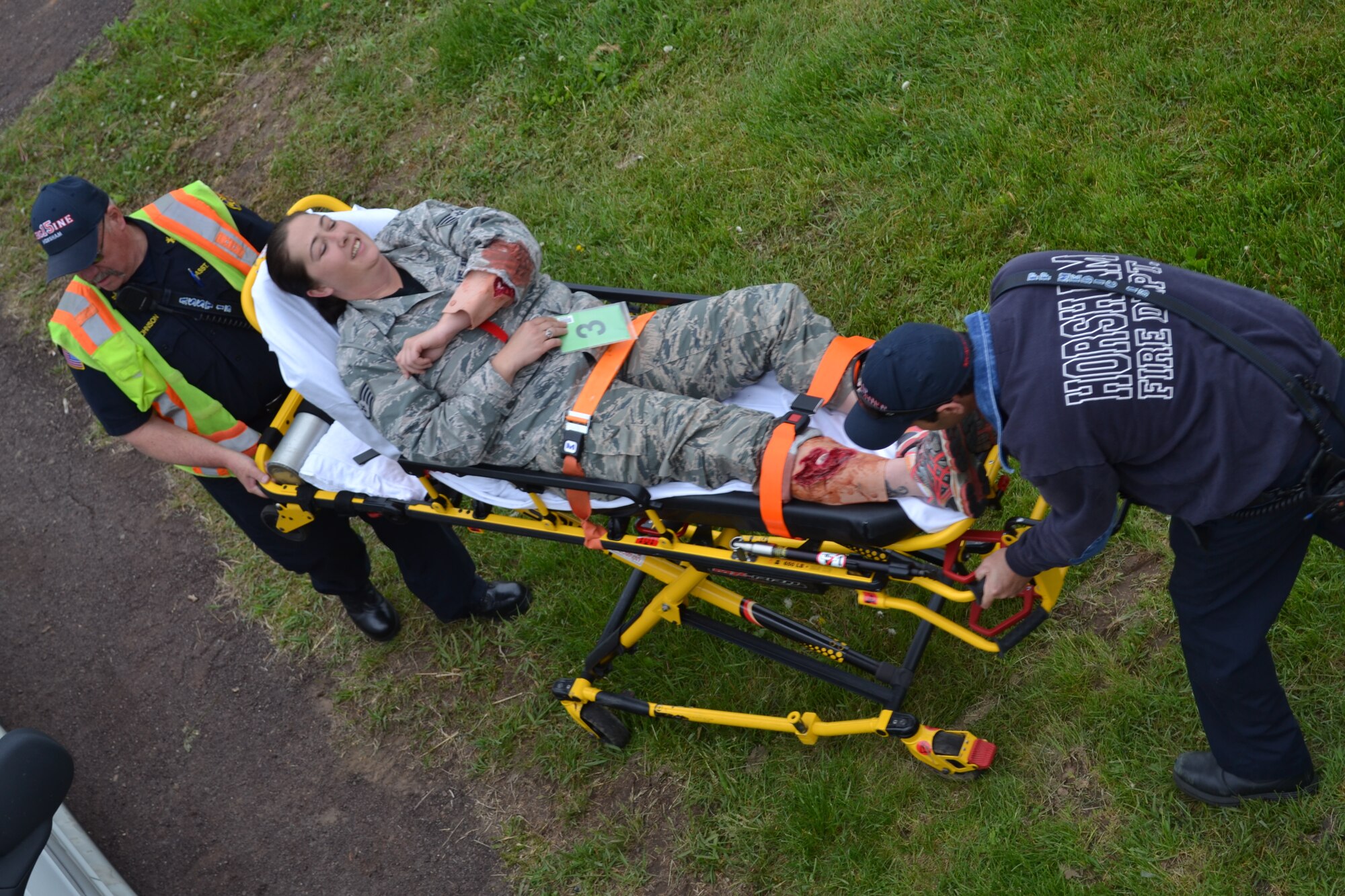 Two members of the Horsham Fire Department perform emergency medical services on a 111th Attack Wing member playing the role of a gunshot victim during a major accident response exercise held at Horsham Air Guard Station, Pa., April 13, 2016. Exercise planners have been incorporating local first responders into exercise scenarios for nearly four years. (U.S. Air National Guard photo by Tech. Sgt. Andria Allmond)
