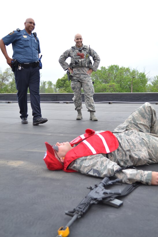 Horsham Police Officer Ramsay Barrington and Staff Sgt. Brian Soto, a 111th Security Forces Squadron member, stand over Master Sgt. Geoffrey Gay, a 201st RED HORSE, Det.1 member, who played the role of an active shooter during a major accident response exercise held at Horsham Air Guard Station, Pa., April 13, 2016. For the past four years, Horsham Police and Fire Departments have participated with Wing members during MAREs. (U.S. Air National Guard photo by Tech. Sgt. Andria Allmond)
