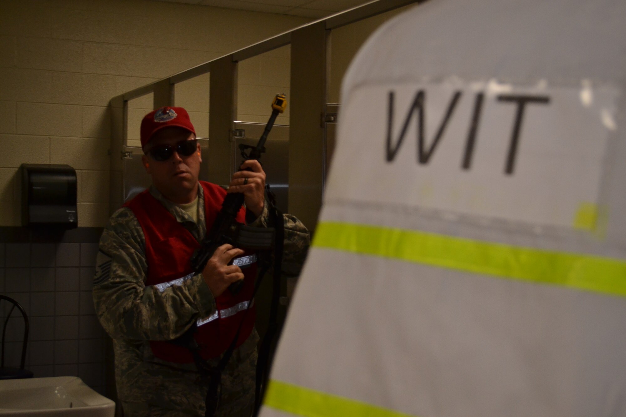 Master Sgt. Geoffrey Gay, a 201st RED HORSE, Det.1 member, plays the part of an active shooter while a wing inspection team (WIT) member watches during a major accident response exercise held at Horsham Air Guard Station, Pa., April 13, 2016. Members of both the Horsham Police Department and the 111th Security Forces Squadron from Horsham AGS worked together to neutralize the dangerous scenario. (U.S. Air National Guard photo by Tech. Sgt. Andria Allmond)
