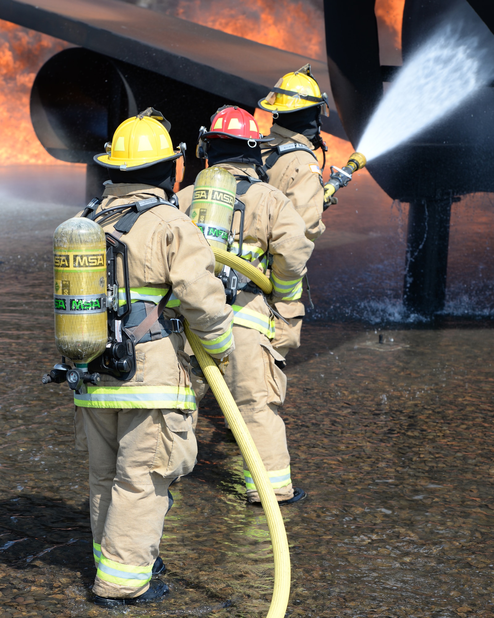 Aircraft rescue firefighters from the 157th Civil Engineer Squadron, Pease Air National Guard Base, N.H., use a handline to extinguish a simulated aircraft structural fire at Logan International Airport, Boston, May 12, 2016.  This is type of training is annual requirement for the firefighters.  (U.S. Air National Guard photo by Staff Sgt. Curtis J. Lenz)