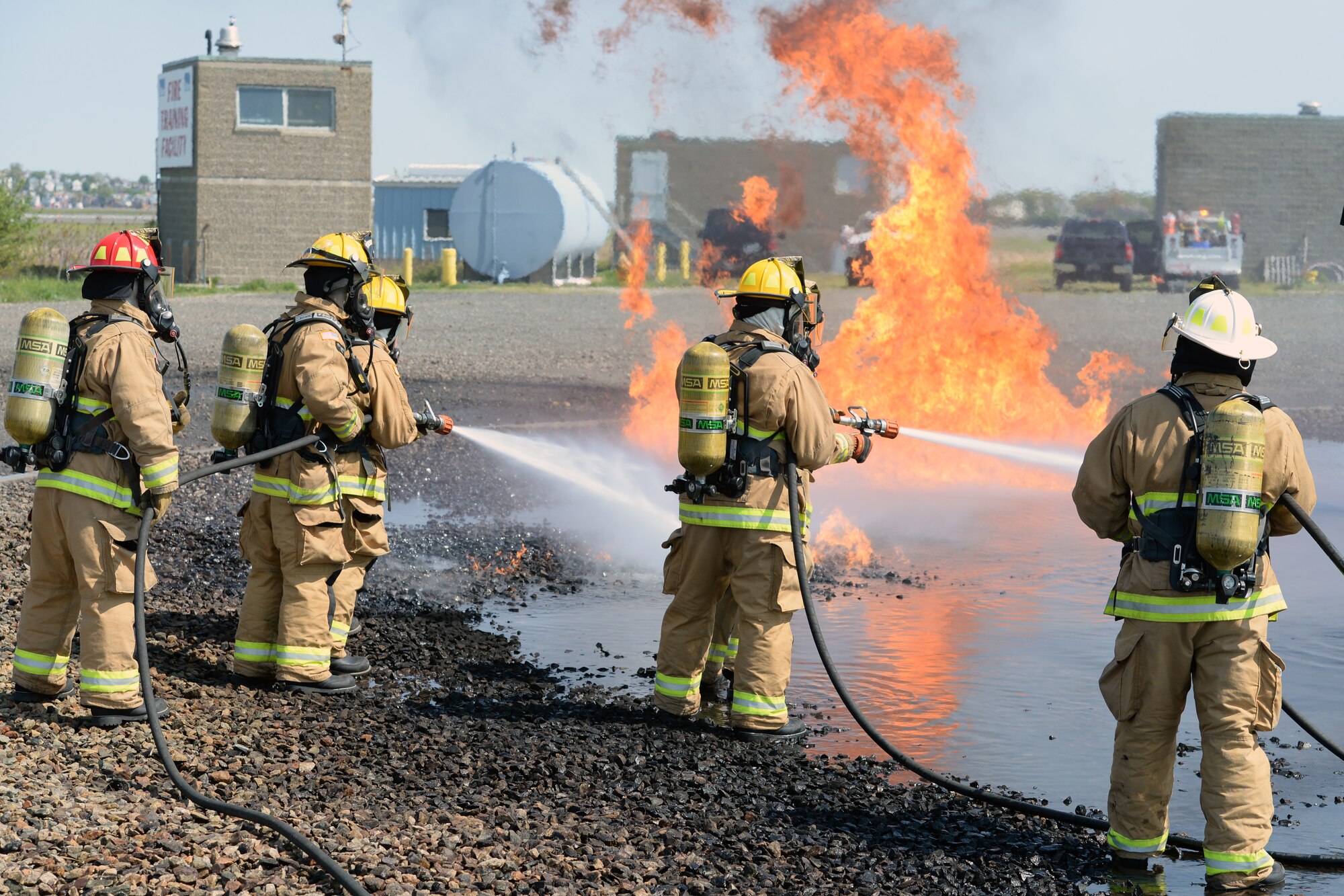 Aircraft rescue firefighters from the 157th Civil Engineer Squadron, Pease Air National Guard Base, N.H., use a handline to extinguish a simulated aircraft structural fire at Logan International Airport, Boston, May 12, 2016.  This is type of training is annual requirement for the firefighters.  (U.S. Air National Guard photo by Staff Sgt. Curtis J. Lenz)