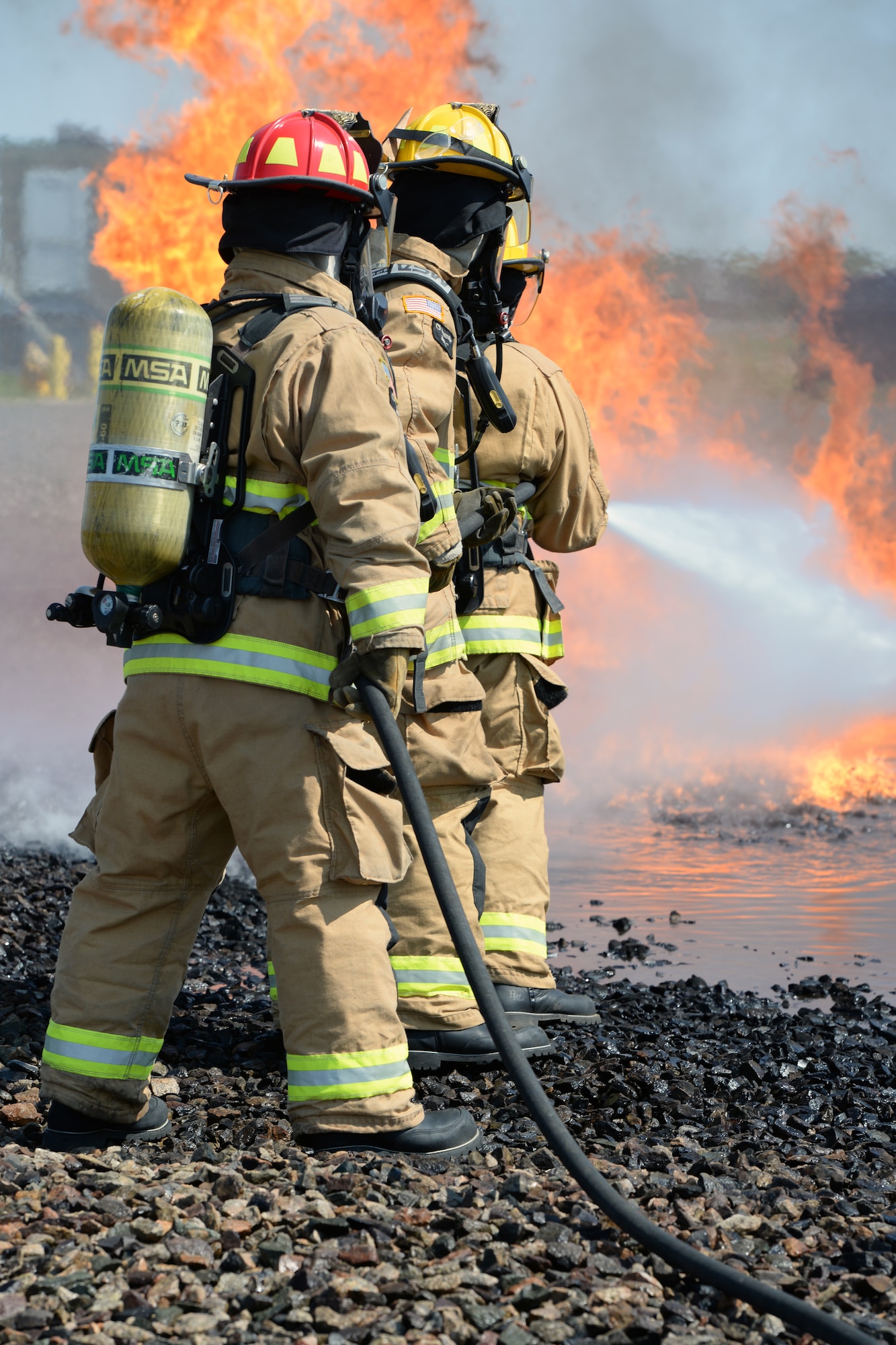 Aircraft rescue firefighters from the 157th Civil Engineer Squadron, Pease Air National Guard Base, N.H., use a handline to extinguish a simulated aircraft structural fire at Logan International Airport, Boston, May 12, 2016.  This is type of training is annual requirement for the firefighters.  (U.S. Air National Guard photo by Staff Sgt. Curtis J. Lenz)