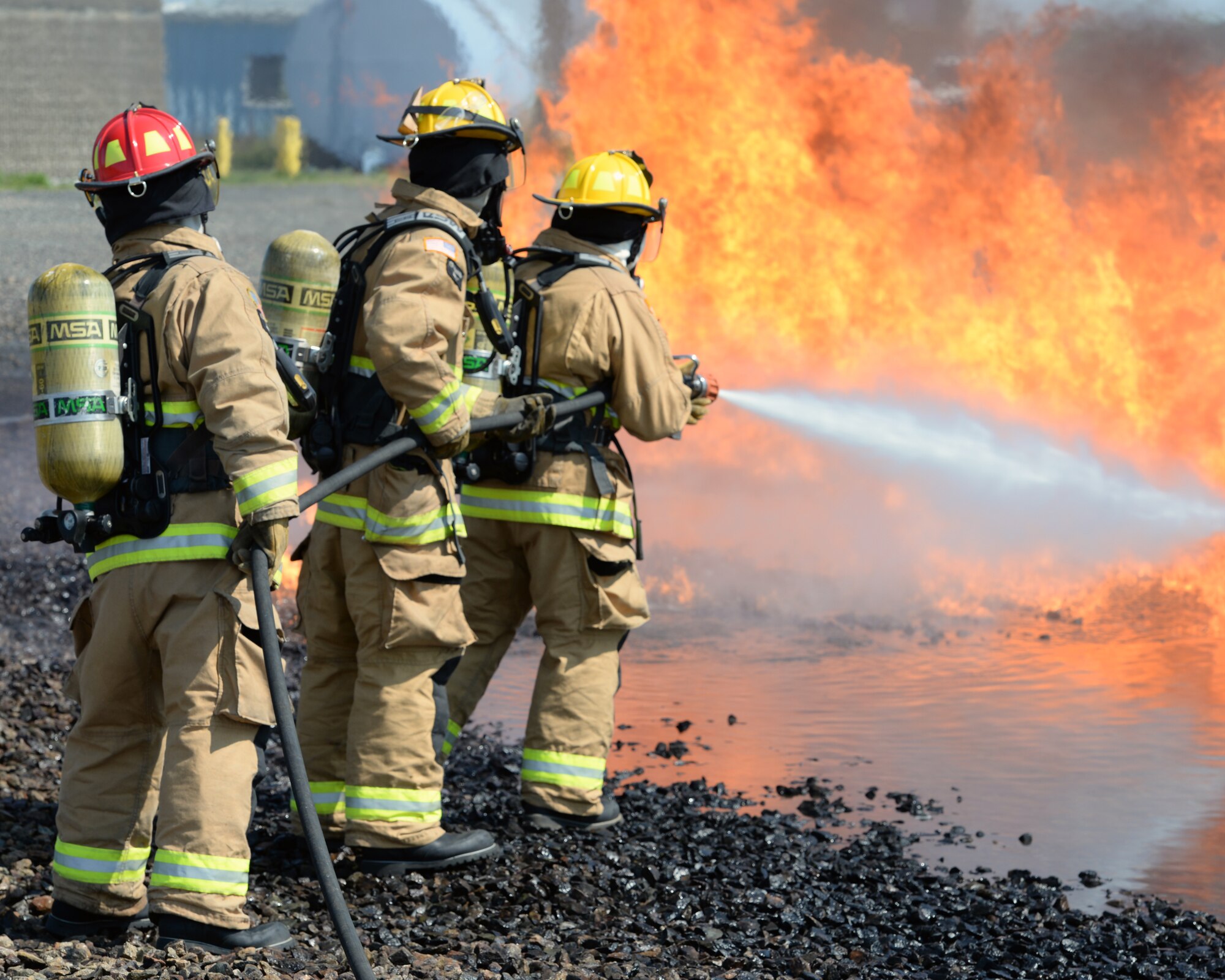 Aircraft rescue firefighters from the 157th Civil Engineer Squadron, Pease Air National Guard Base, N.H., use a handline to extinguish a simulated aircraft structural fire at Logan International Airport, Boston, May 12, 2016.  This is type of training is annual requirement for the firefighters.  (U.S. Air National Guard photo by Staff Sgt. Curtis J. Lenz)
