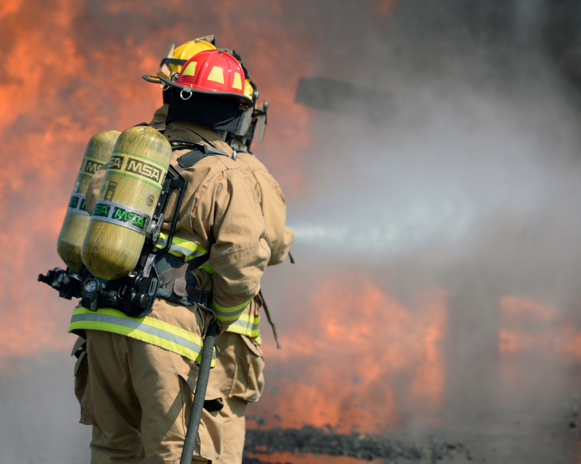 Aircraft rescue firefighters from the 157th Civil Engineer Squadron, Pease Air National Guard Base, N.H., use a handline to extinguish a simulated aircraft structural fire at Logan International Airport, Mass., May 12, 2016.  This is type of training is annual requirement for the firefighters.  (U.S. Air National Guard photo by Staff Sgt. Curtis J. Lenz)