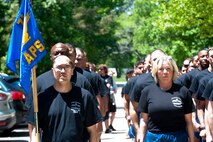 U.S. Air Force Airmen assigned to the 71st Aerial Port Squadron stand in formation during a memorial ceremony at Langley Air Force Base, Va., May 14, 2016. The ceremony honored five fallen air transportation Airmen and raised more than $800 for the Fisher House charity.(U.S. Air Force photo by Staff Sgt. R. Alex Durbin)