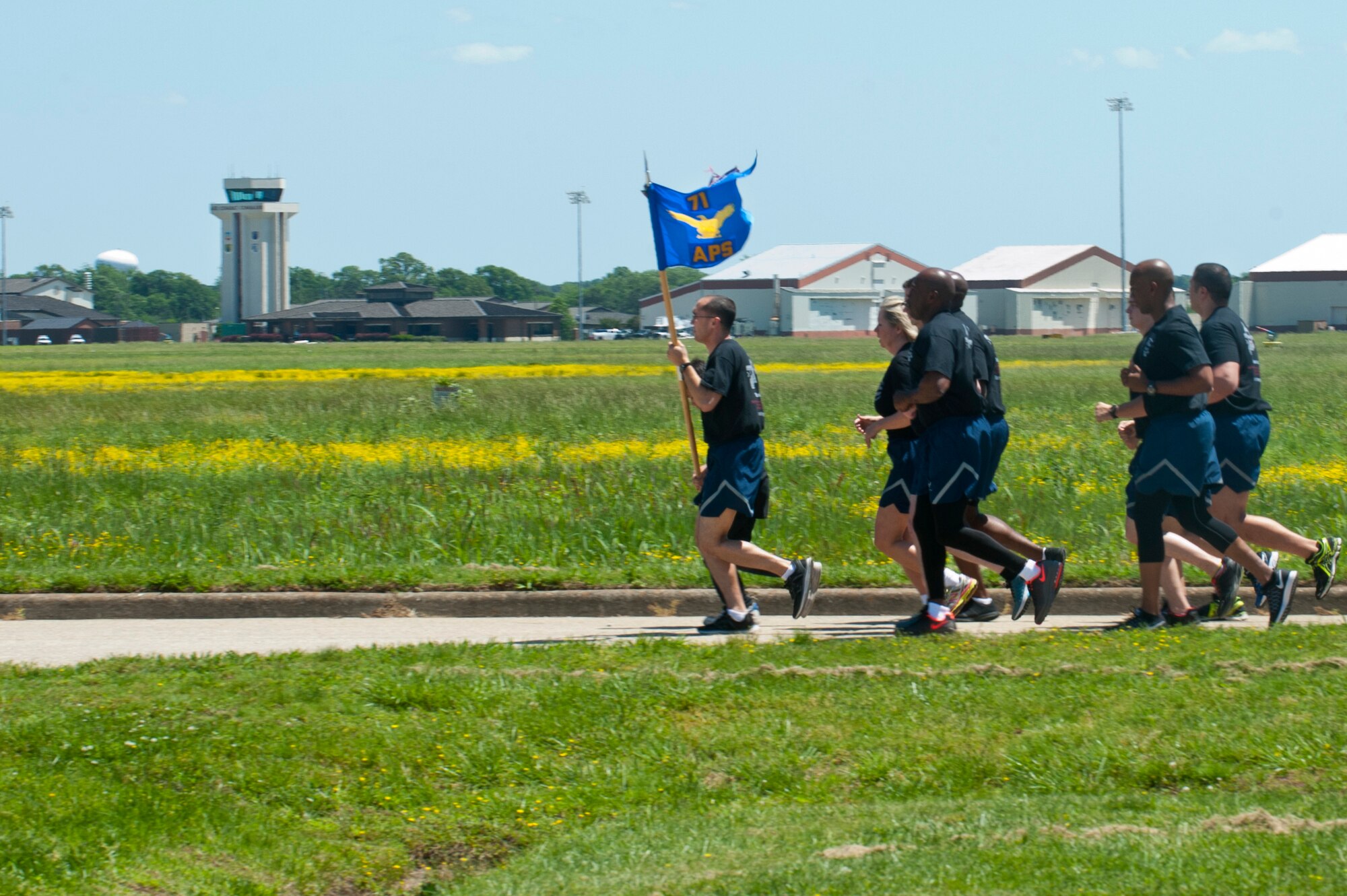 U.S. Air Force Reserves Airmen assigned to the 71st Aerial Port Squadron run in formation during a memorial ceremony at Langley Air Force Base, Va., May 14, 2016. The 71st APS is an Air Force Reserve unit that provides the military logistical functions of processing personnel and cargo, rigging for airdrop and packing parachutes. (U.S. Air Force photo by Staff Sgt. R. Alex Durbin)