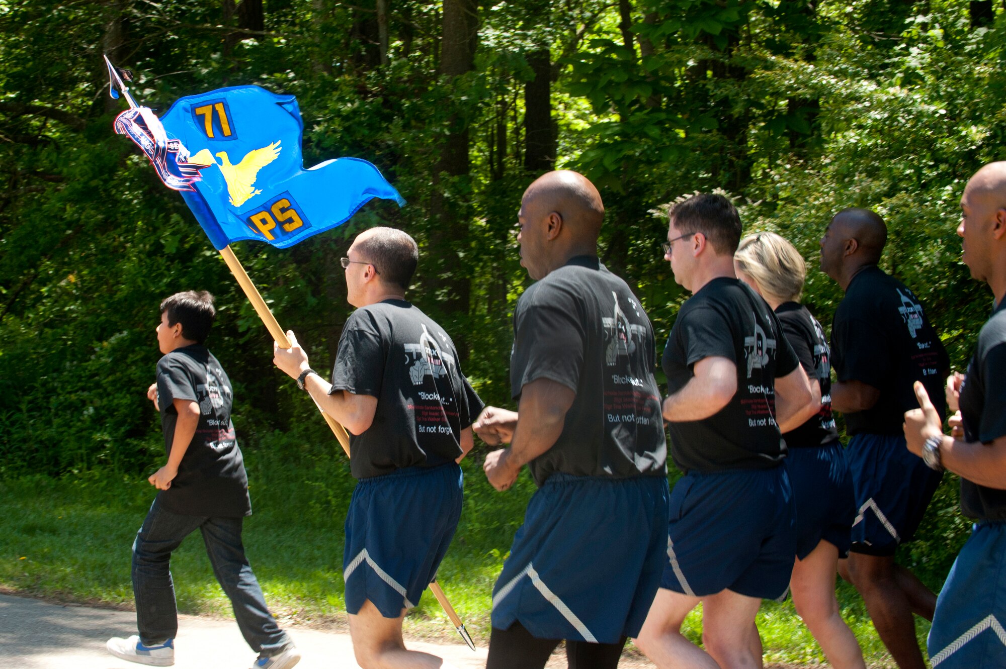 U.S. Air Force Reserves Airmen assigned to the 71st Aerial Port Squadron run in formation during a memorial ceremony at Langley Air Force Base, Va., May 14, 2016. This year, the squadron honored five air transportation Airmen, including Tech. Sgt. Isaac Gervasio who served in the 71st APS before his death in November 2015. (U.S. Air Force photo by Staff Sgt. R. Alex Durbin)