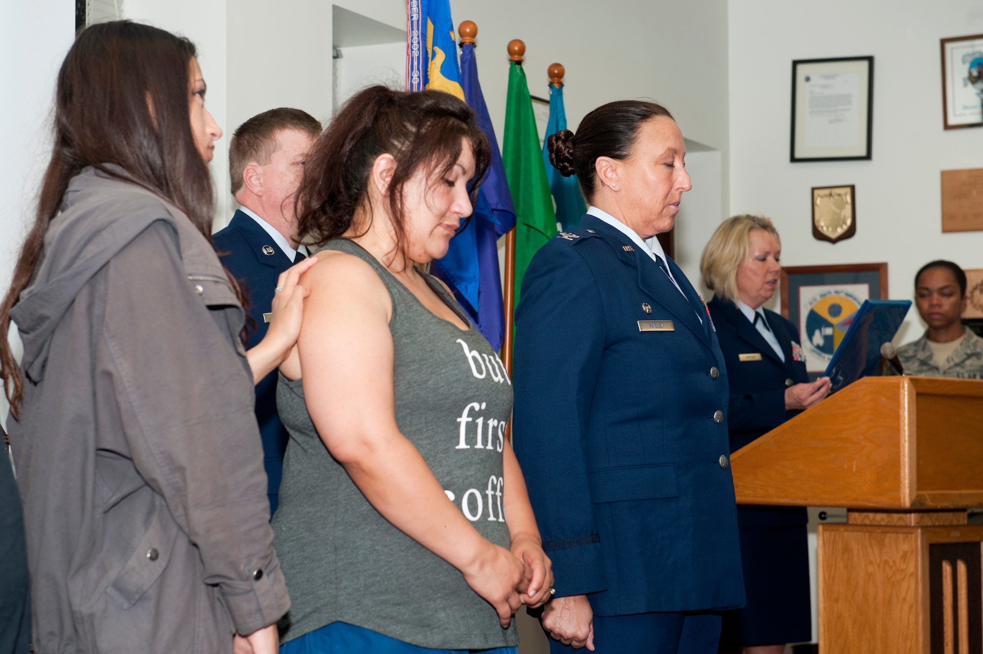 Jessica and Sophia Gervasio, the wife and daughter of U.S. Air Force Reserves Tech. Sgt. Isaac Gervasio, listen to an Airman with the 71st Aerial Port Squadron read Isaac’s accomplishments during a memorial ceremony at Langley Air Force Base, Va., May 14, 2016. The remembrance ceremony honored Gervasio and four other air transportation Airmen who lost their lives in 2015. (U.S. Air Force photo by Staff Sgt. R. Alex Durbin)