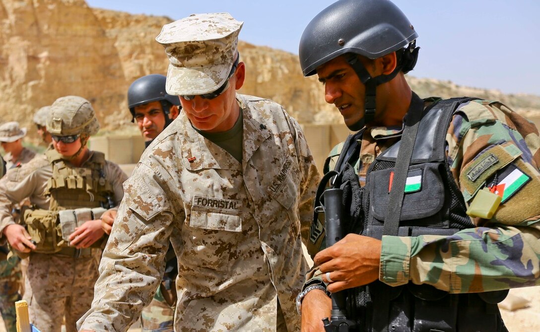 U.S. Marine CWO-2 Ronald P. Forristal, Battalion Gunner for 2nd Battalion, 7th Marine Regiment, Special Purpose Marine Air Ground Task Force Crisis Response Central Command 16.2, discusses shot groups with a member of the Jordanian Armed Forces from his battle sight zero drills during Exercise Eager Lion 16. (U.S. Marine Corps photo by Cpl. Lauren Falk)