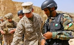 U.S. Marine CWO-2 Ronald P. Forristal, Battalion Gunner for 2nd Battalion, 7th Marine Regiment, Special Purpose Marine Air Ground Task Force Crisis Response Central Command 16.2, discusses shot groups with a member of the Jordanian Armed Forces from his battle sight zero drills during Exercise Eager Lion 16. (U.S. Marine Corps photo by Cpl. Lauren Falk)