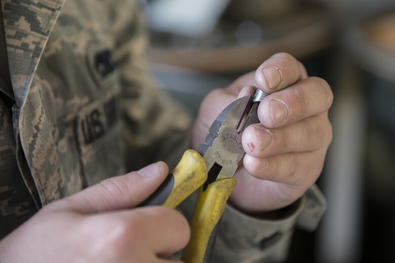 U.S. Air Force Senior Airman Scott Thorp, a 354th Maintenance Squadron metals technician, cuts coils to replace threads for a Mark 82 bomb, May 10, 2016, on Eielson Air Force Base, Alaska. Each member plays an important role when assembling the MK 82 from start to finish. (U.S. Air Force photo by Staff Sgt. Ashley Nicole Taylor/Released)
