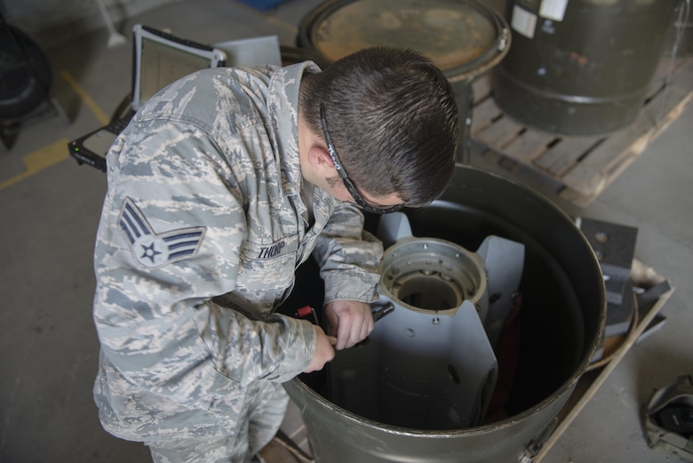 U.S. Air Force Senior Airman Scott Thorp, a 354th Maintenance Squadron metals technician, replaces threads on a Mark 82 bomb, May 10, 2016, on Eielson Air Force Base, Alaska. The Aircraft Munitions Maintenance Organization shop handles each MK 82 from start to finish. (U.S. Air Force photo by Staff Sgt. Ashley Nicole Taylor/Released)
