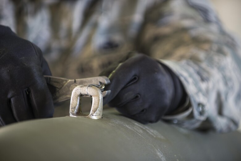 U.S. Air Force Master Sgt. Anthonio Dais, the 8th Maintenance Squadron NCO in charge of precision guided munitons, assigned to Kunsan Air Base, Republic of South Korea, wires a Mark 82 bomb during RED FLAG-Alaska (RF-A) 16-1, May 10, 2016, at Eielson Air Force Base, Alaska. Dais said he enjoys participating in RF-A because he gets an opportunity for realistic, hands-on training in a simulated combat exercise. (U.S. Air Force photo by Staff Sgt. Ashley Nicole Taylor/Released) 

