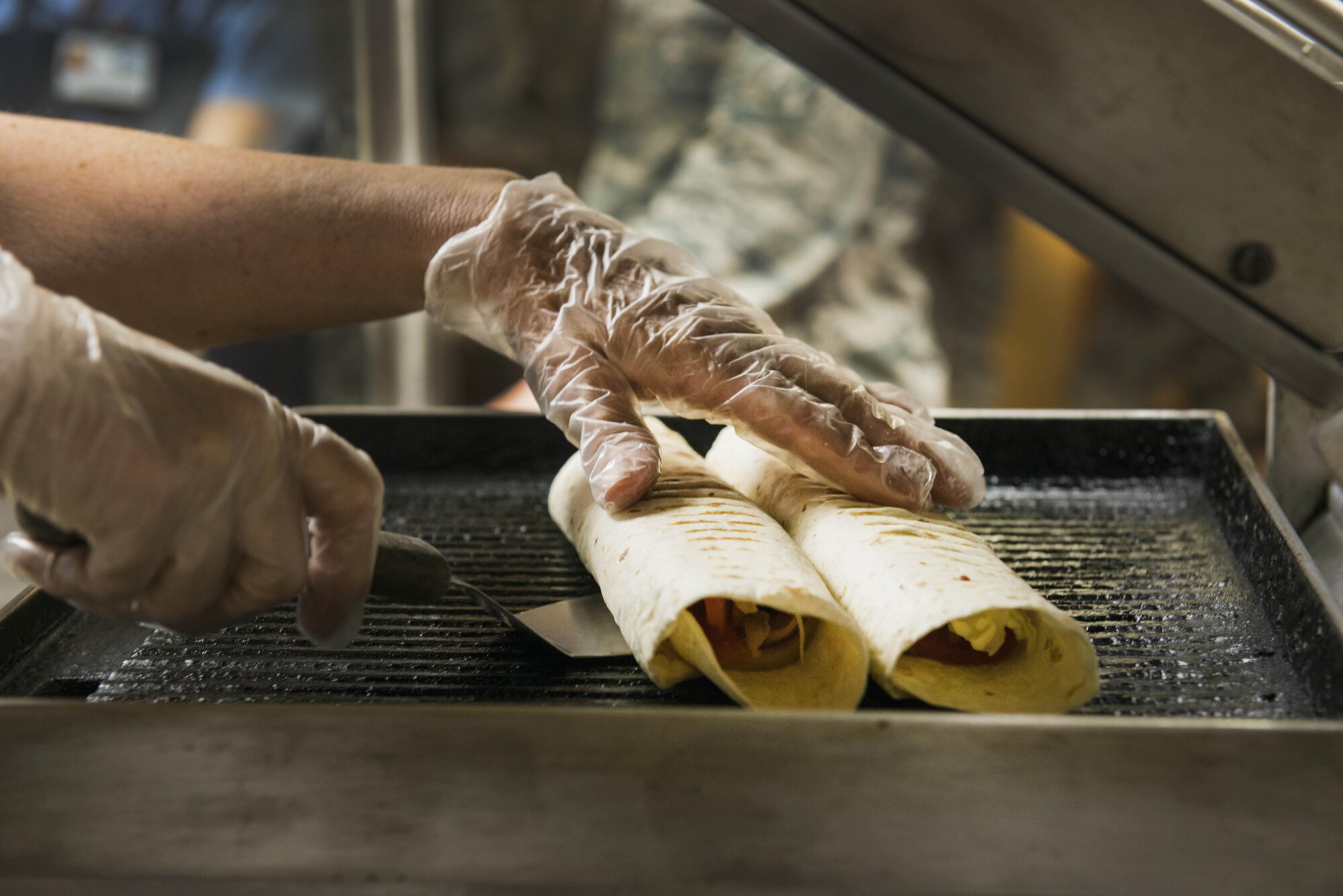A grilled wrap is one of the many options available during lunch, May 11, 2016, in the Two Seasons Dining Facility, Eielson Air Force Base, Alaska. The Two Seasons Dining Facility serves four meals during RED FLAG-Alaska and are always preparing or cooking food to keep up with the large amount of servicemembers to feed. U.S. Air Force photo by Staff Sgt. Ashley Nicole Taylor/Released)